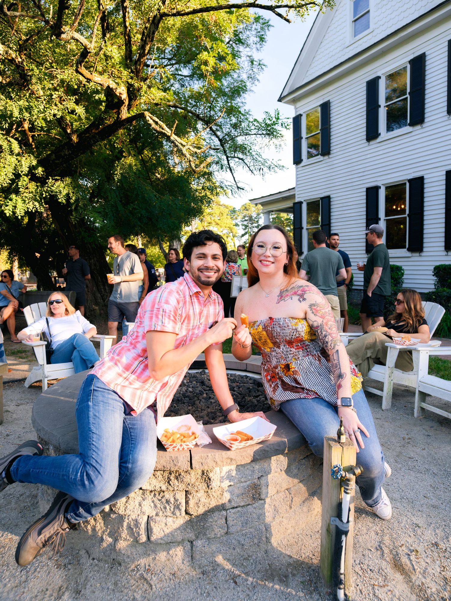People sitting on a large rock wall at sunset, captured in a series of casual outdoor photos during a gathering.