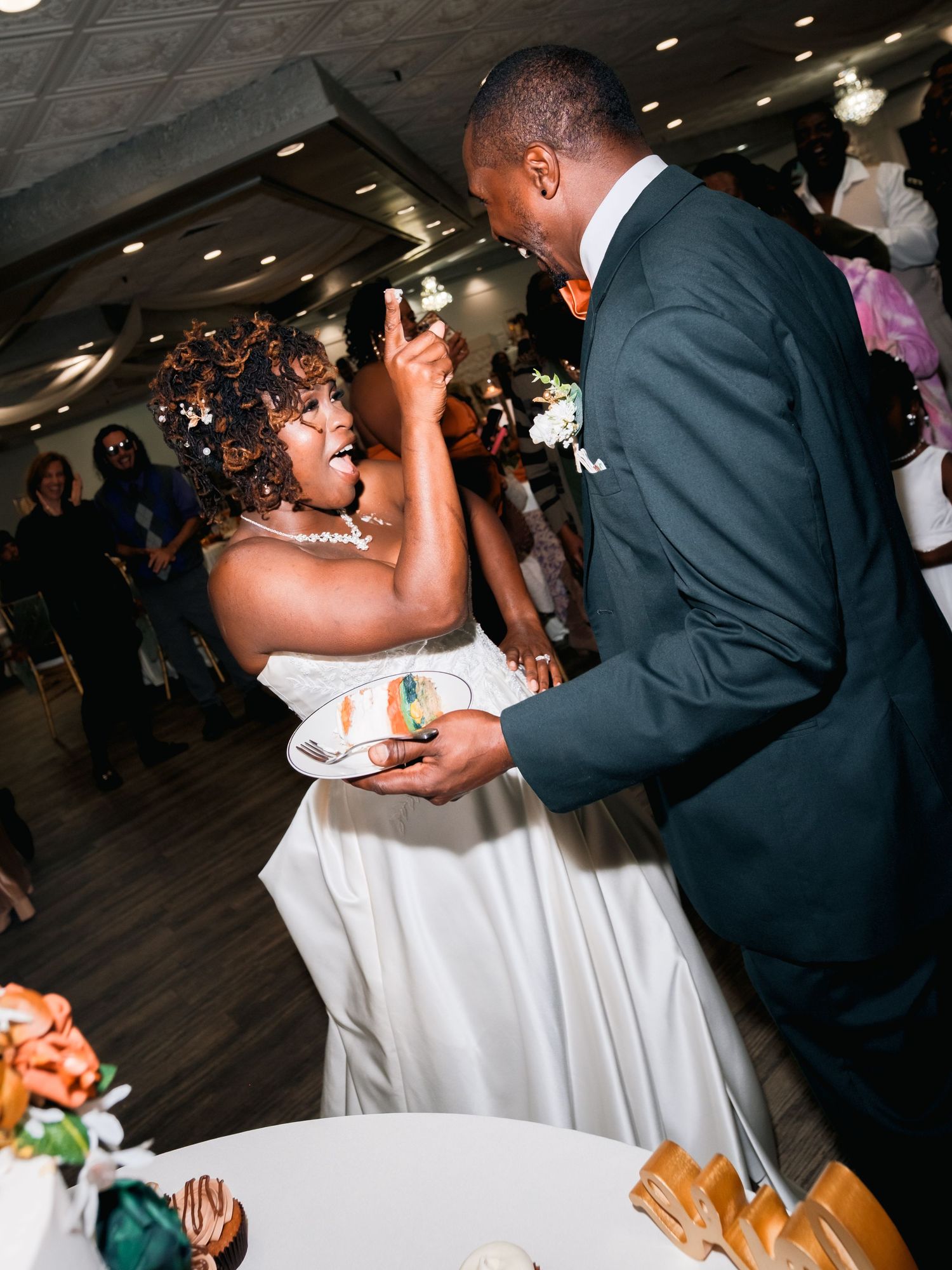 A couple in formal wedding attire share a sweet moment during their first dance at the reception.