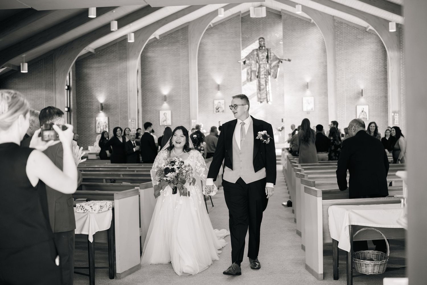 Black and white photos capture joyful moments from an elegant wedding celebration at a grand venue.