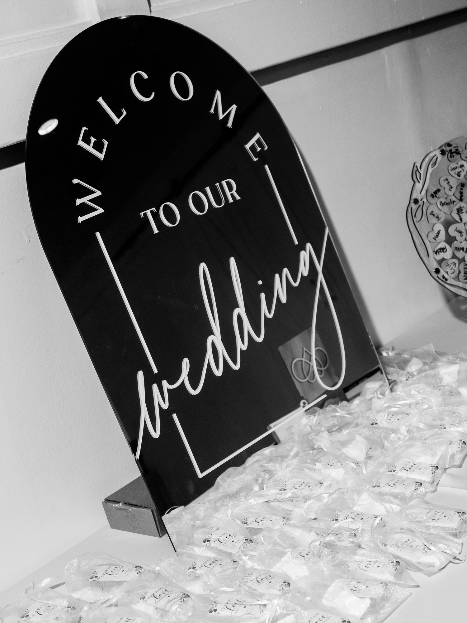 Black and white welcome signs with elegant script lettering displayed at an event.