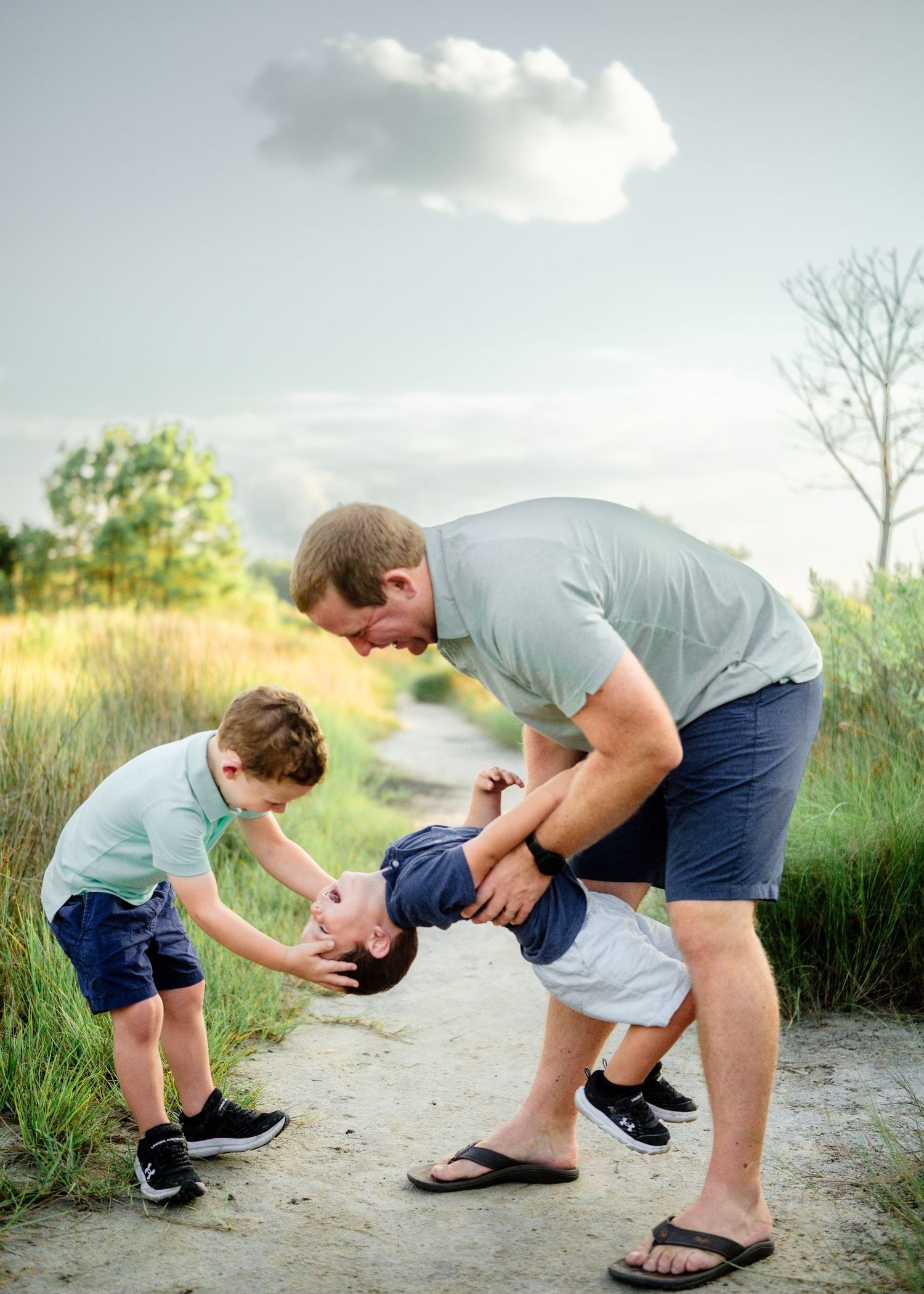 A heartwarming sequence shows a parent and young child sharing a playful moment on a nature path.