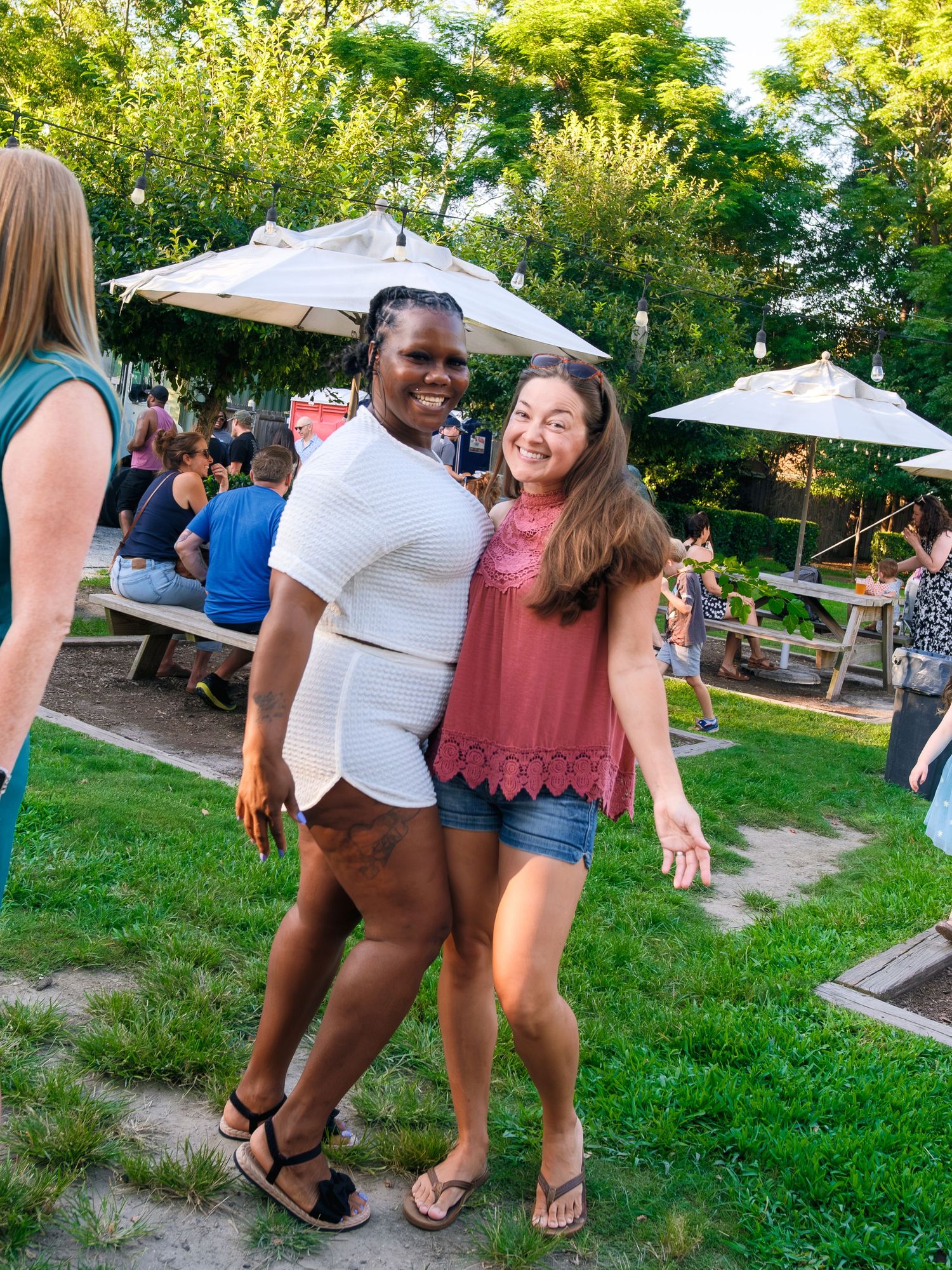 Group of people playing a lawn game together at an outdoor gathering during summer.