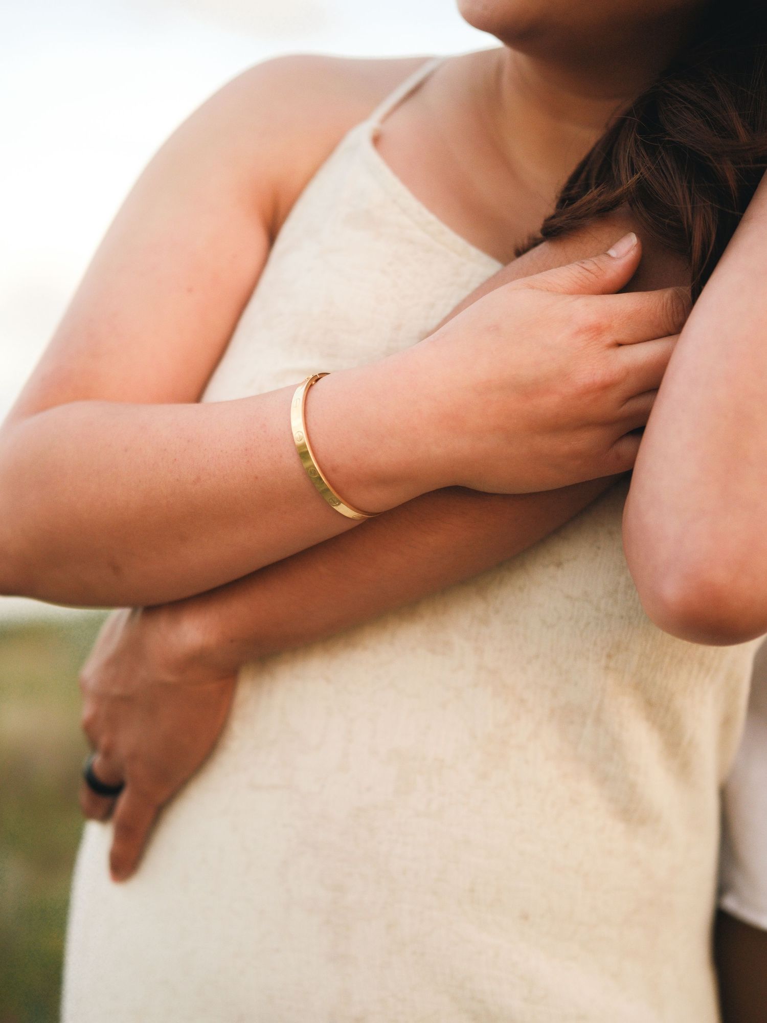 Close-up detail shots of gentle embraces and hands with wedding rings.