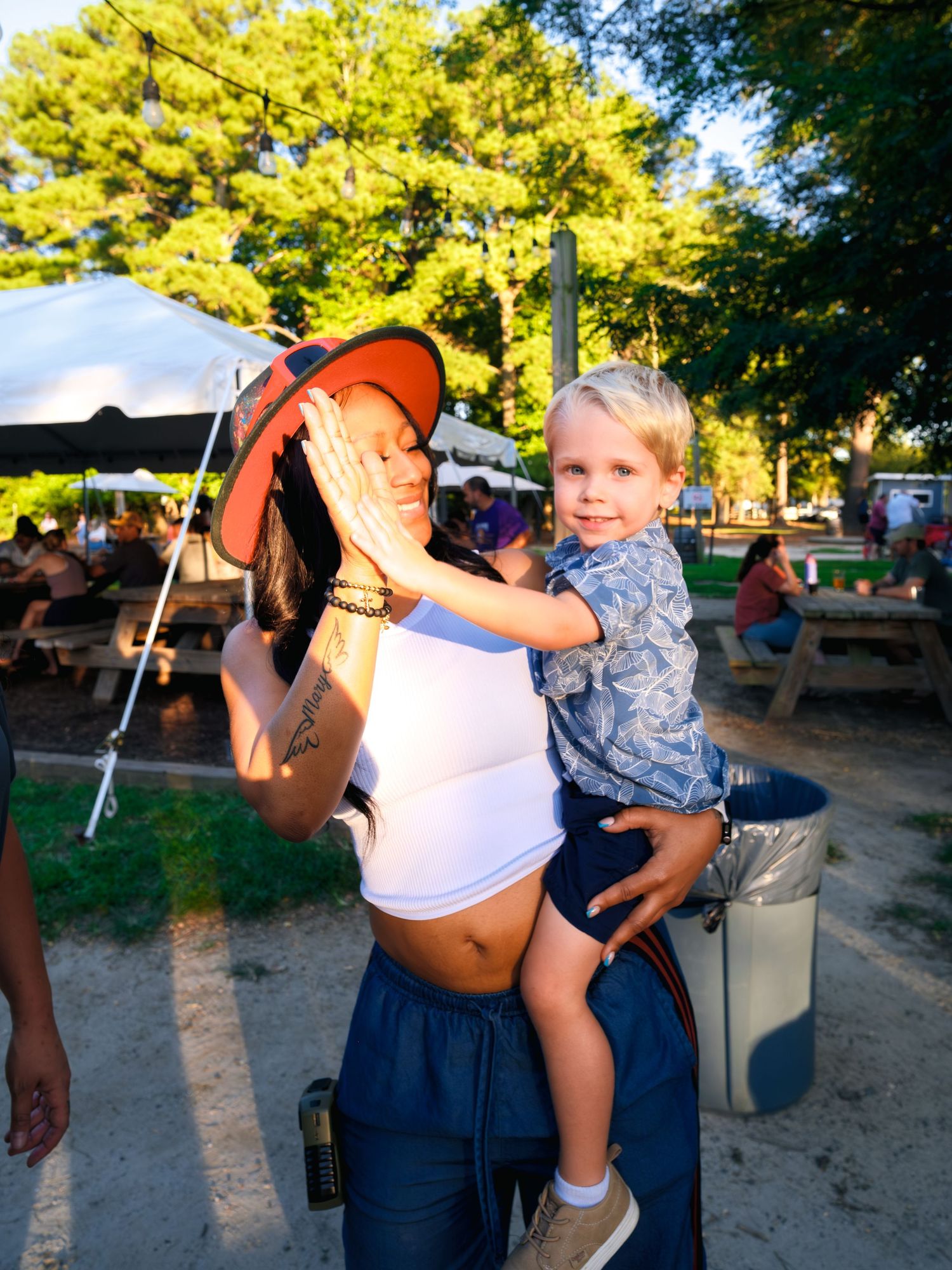 Two children carry out a telescope viewing activity together in an outdoor setting during golden hour.