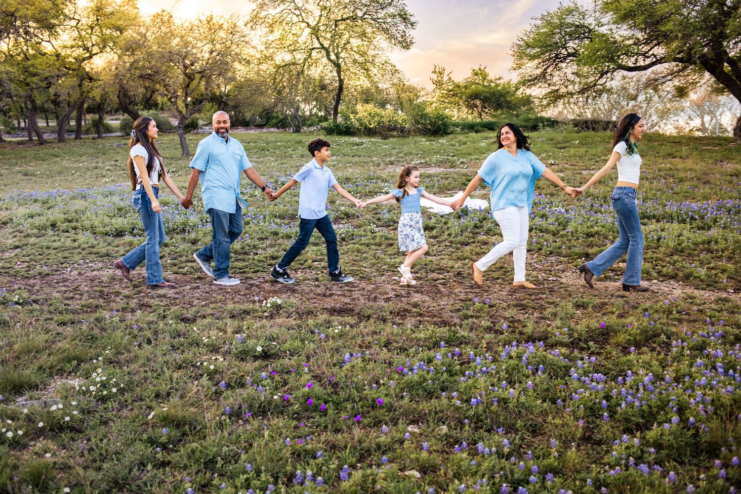 San Antonio family frolicking in the iconic Texas Bluebonnets.