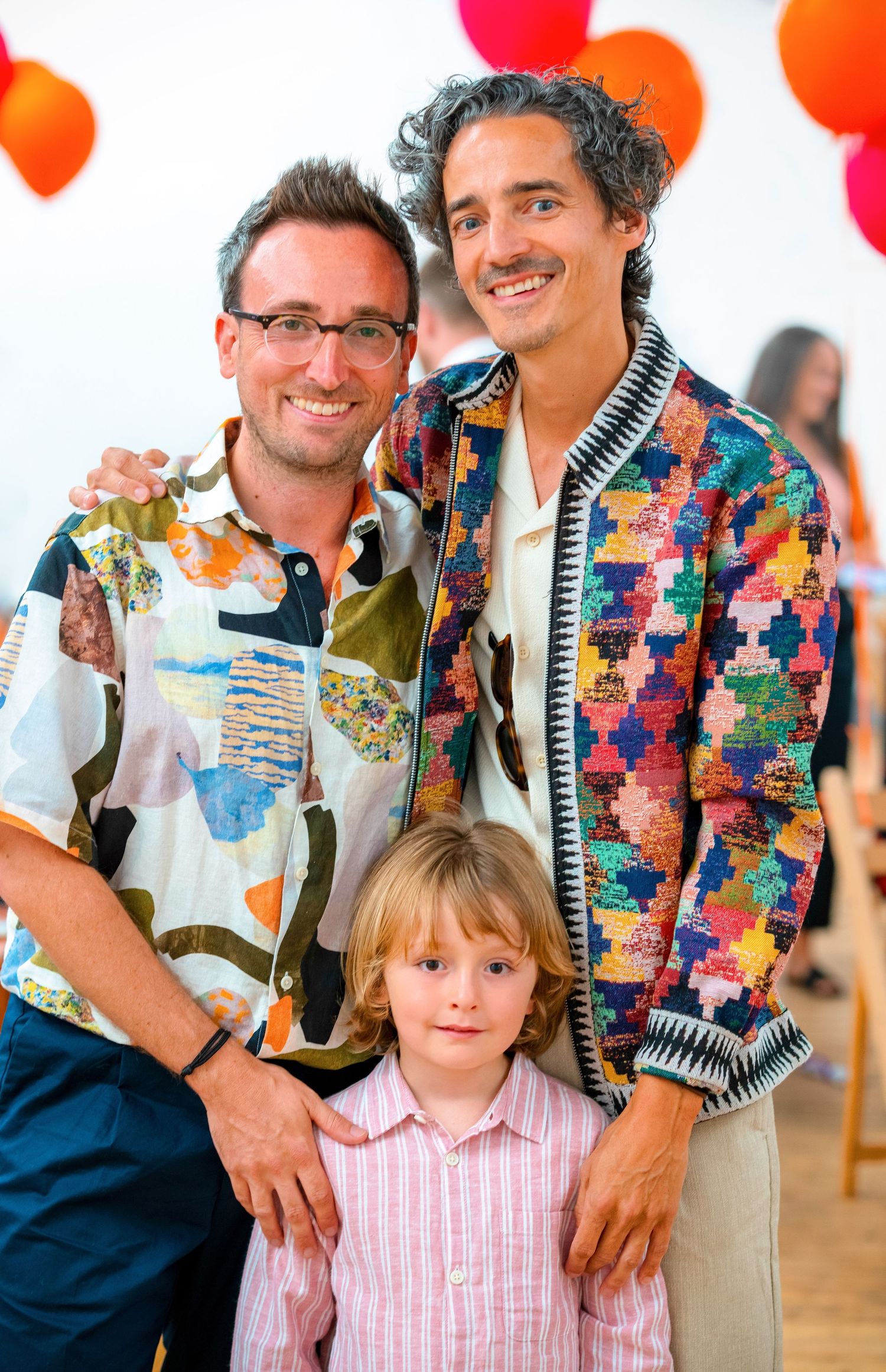 A series of photos showing a person in a colorful patchwork shirt posing with a child in a pink striped dress.