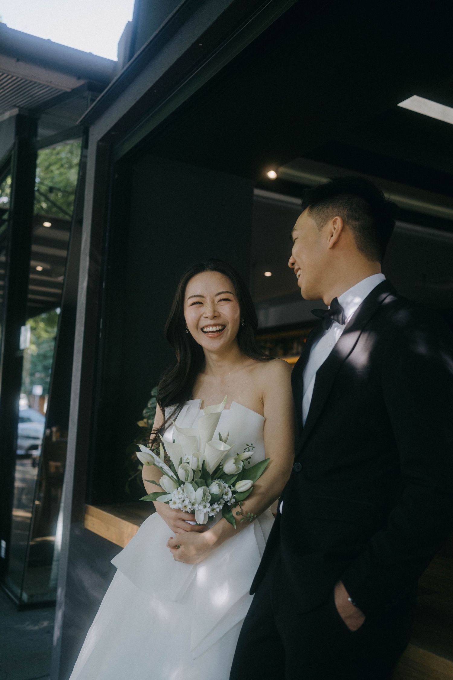A wedding couple shares joyful moments together in a series of candid shots under a covered walkway.