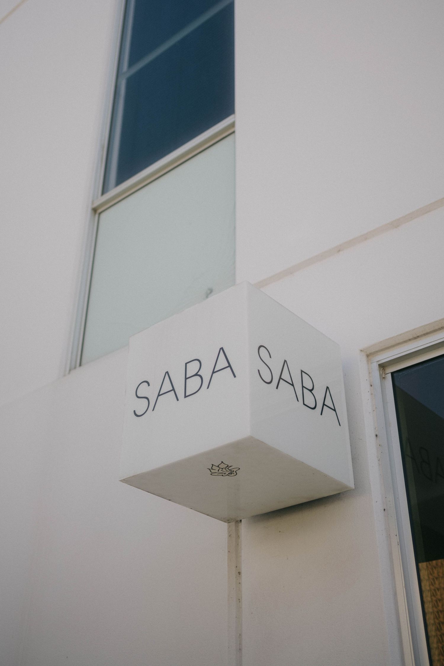 White architectural detail showing a partial view of 'SADA SABA' text on what appears to be a building facade.