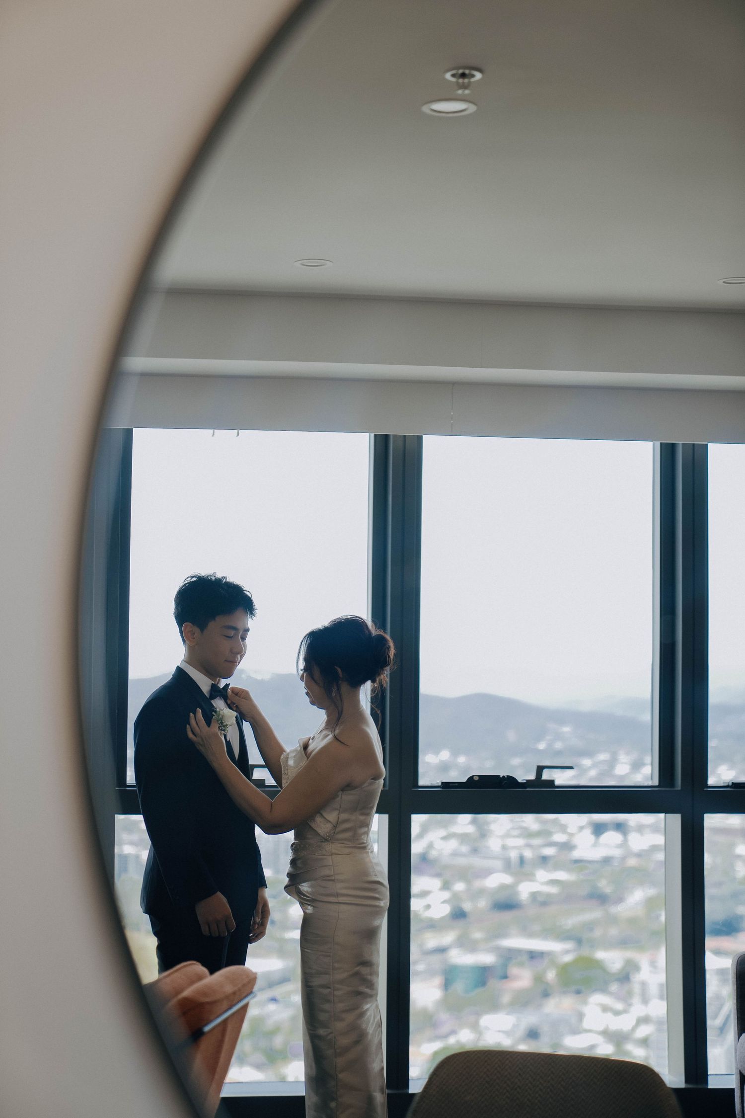 A couple shares an intimate moment by a window overlooking a cityscape in a progression of silhouetted frames.