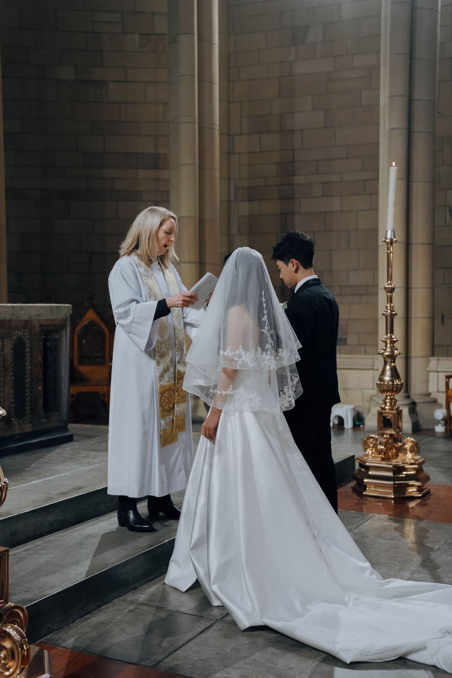 A wedding ceremony sequence showing a bride in a flowing white gown and veil inside a grand stone church interior.