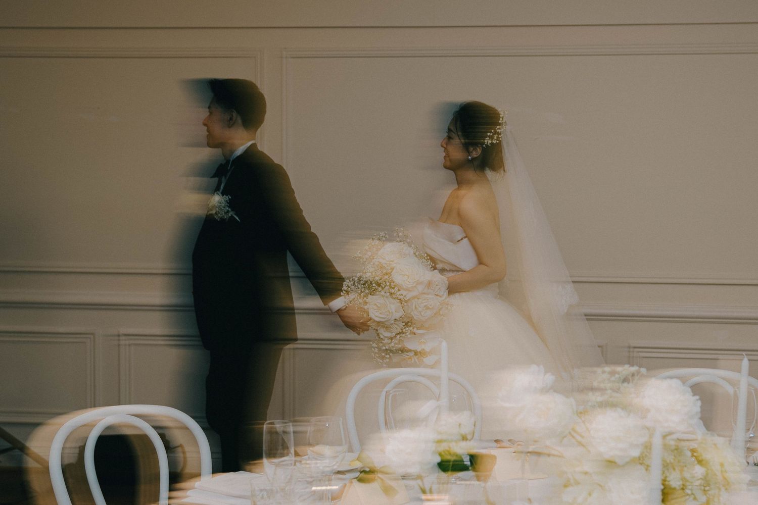 A blurred motion sequence shows a couple in wedding attire dancing together at their reception.