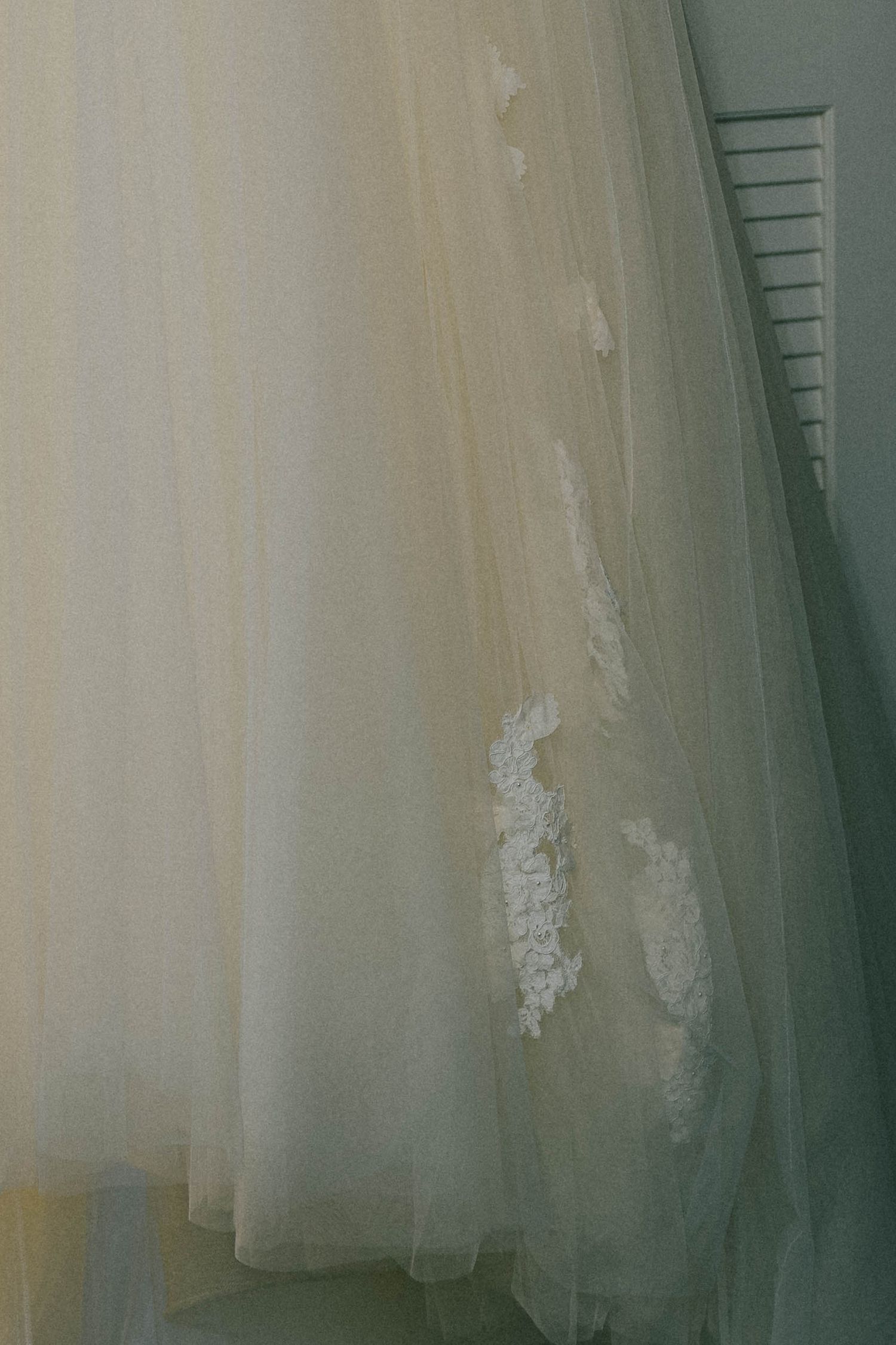 Ethereal layers of sheer white tulle fabric create a dreamy, romantic atmosphere against a soft neutral background.