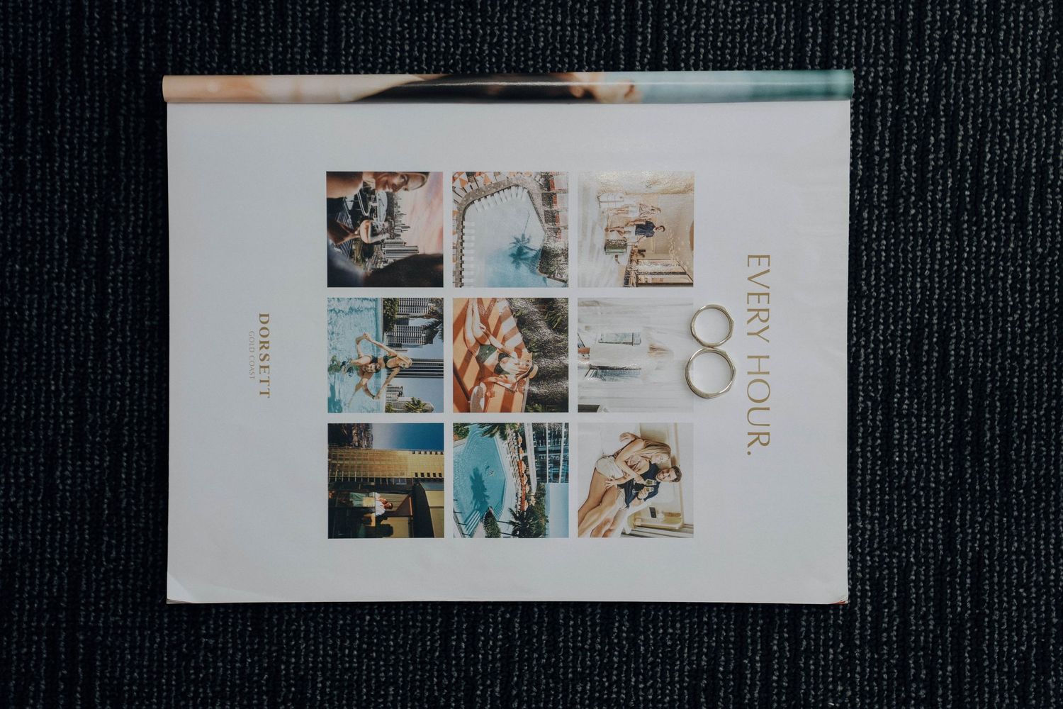 Collection of white brochures and marketing materials arranged in a clean, minimalist display on a dark background.