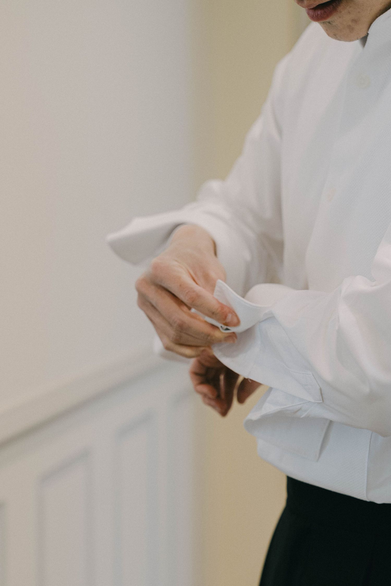 Close-up view of hands folding white paper documents in an office setting.