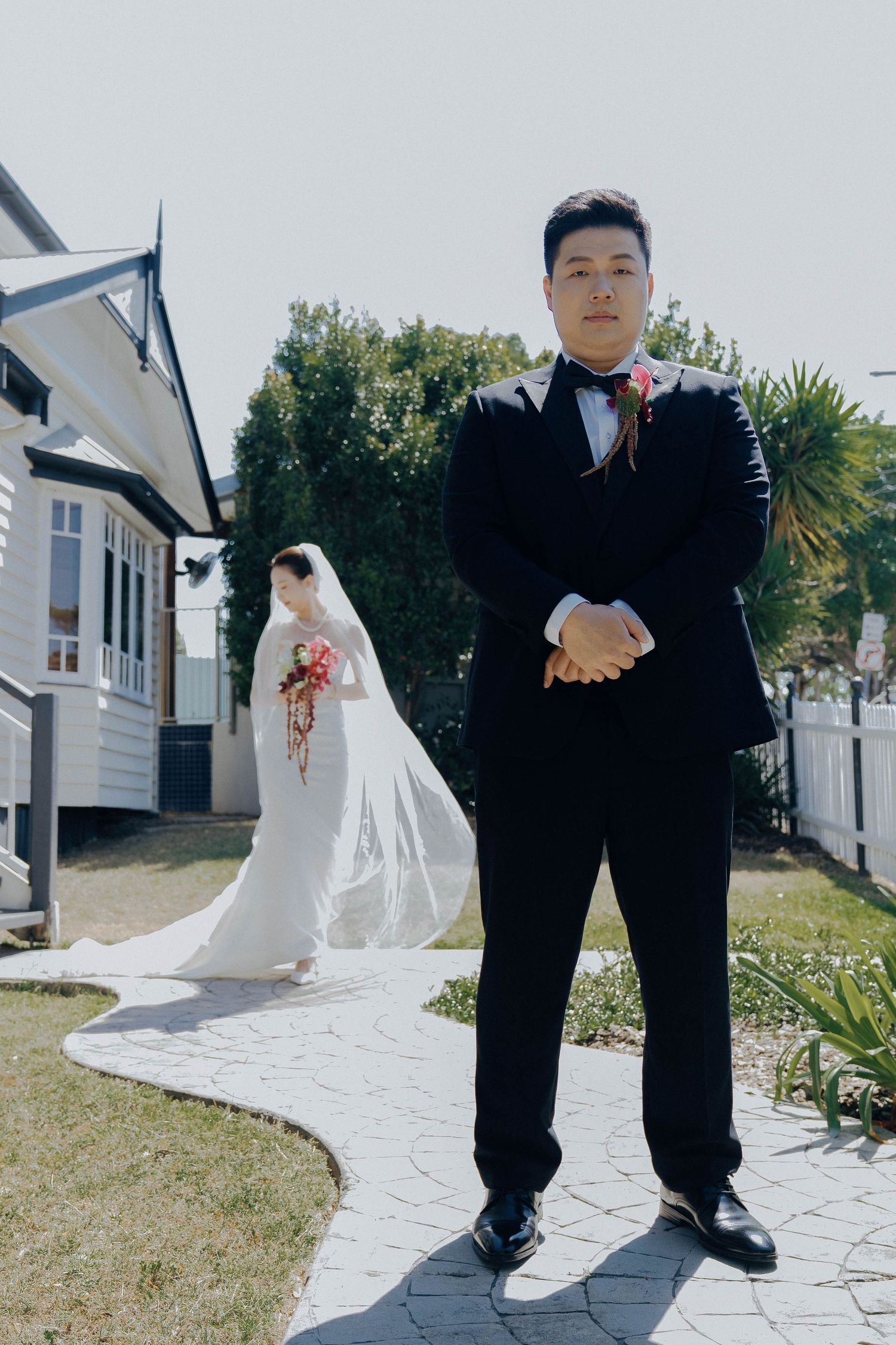 A series of wedding photos showing close-up details of formal attire and white dress trains on a garden path.