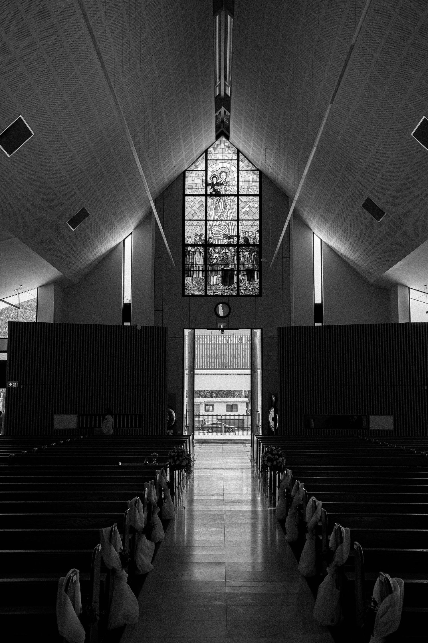 Black and white images show the interior of a church with dramatic lighting and stained glass windows at different angles.