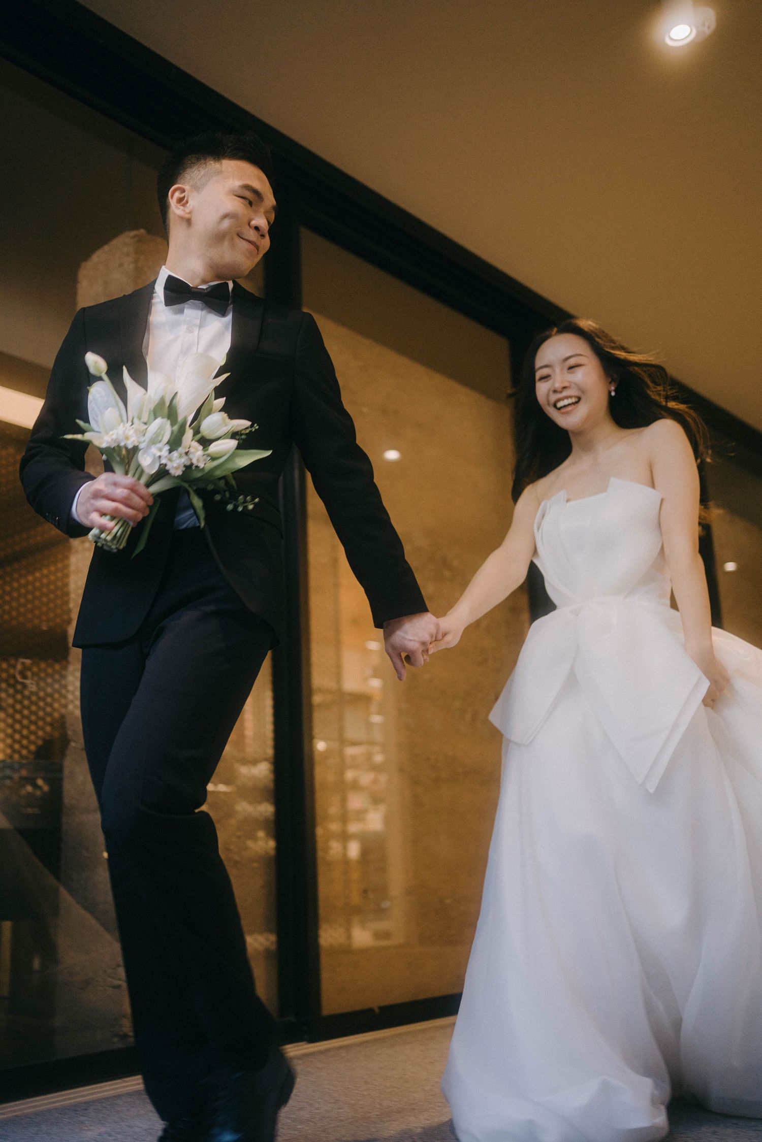 A joyful wedding couple dances together in an indoor venue, creating candid moments across multiple frames.