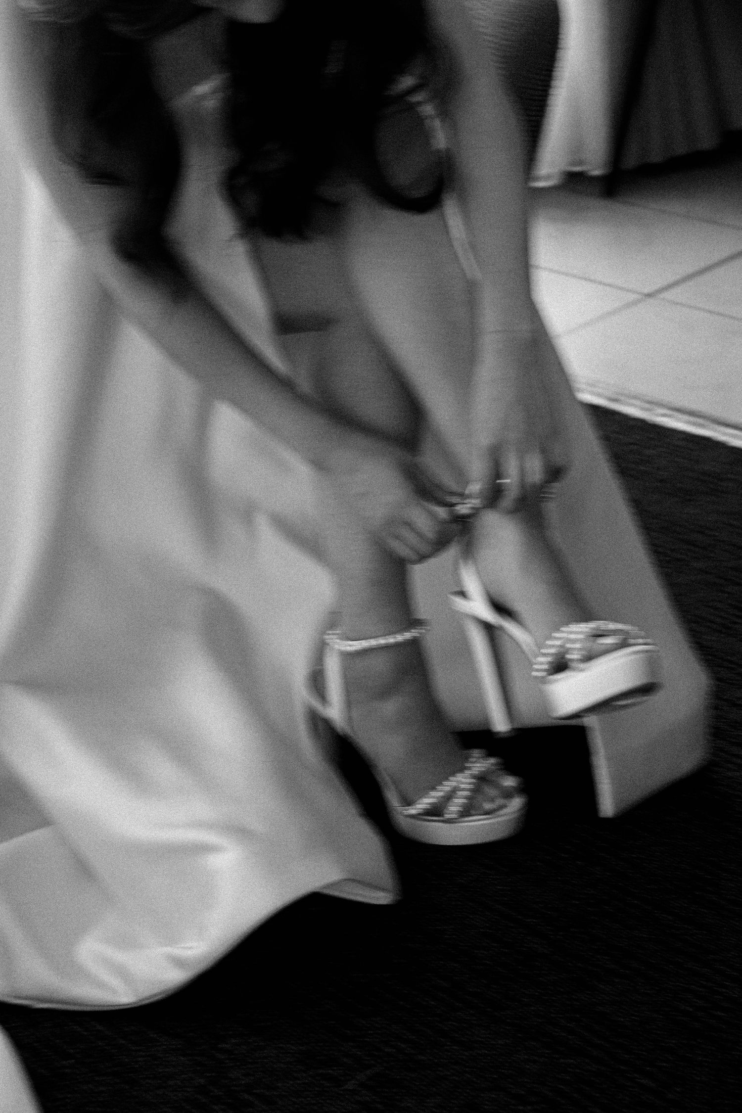 A sequence of black and white images showing a person's feet walking across a dark floor.