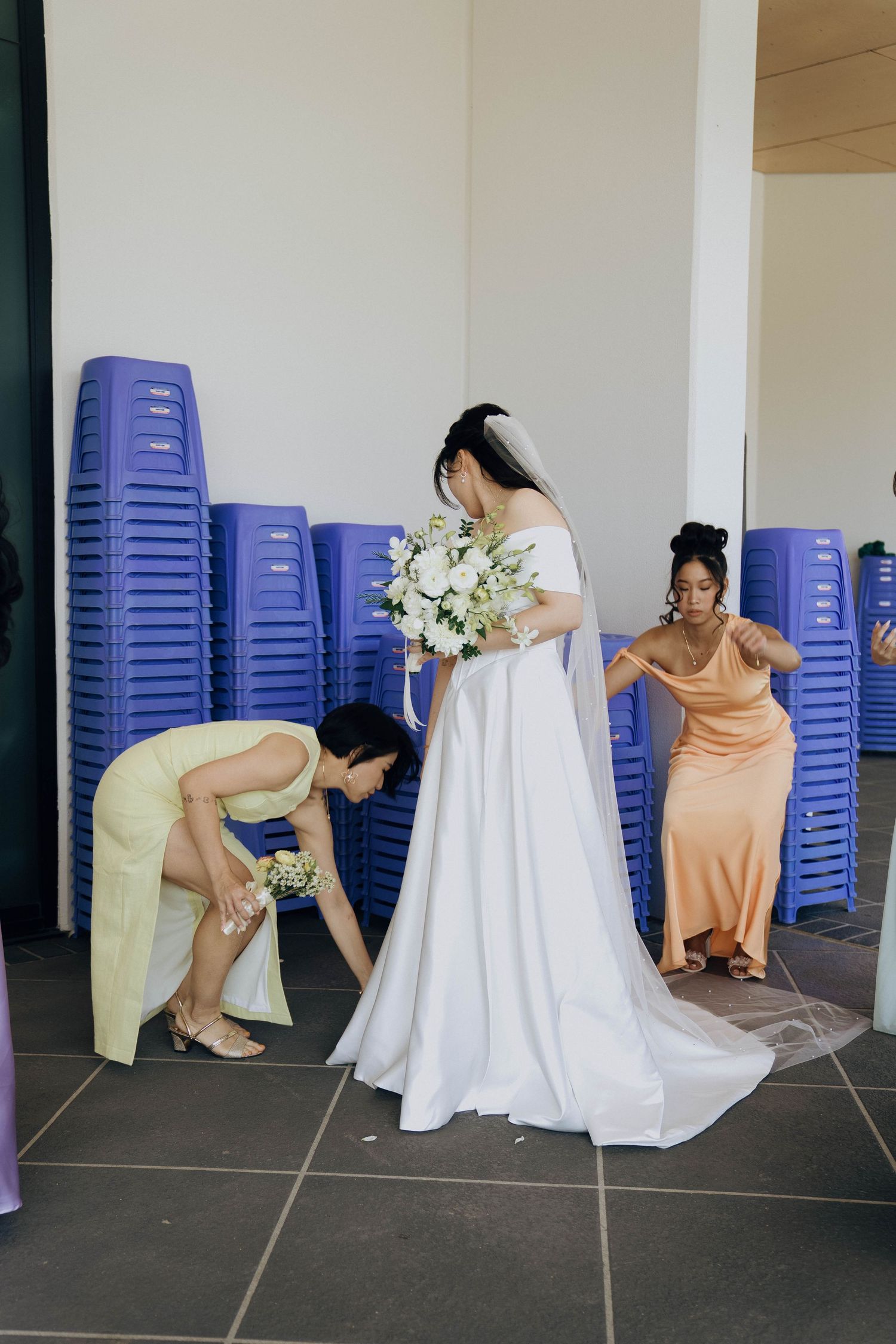 Bridesmaids in peach dresses sit on blue chairs against a white wall in a candid wedding photo sequence.