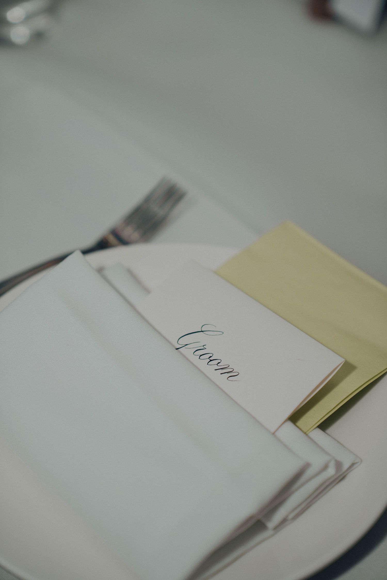 A series of white and yellow paper documents or cards arranged in a minimalist layout on a light surface.