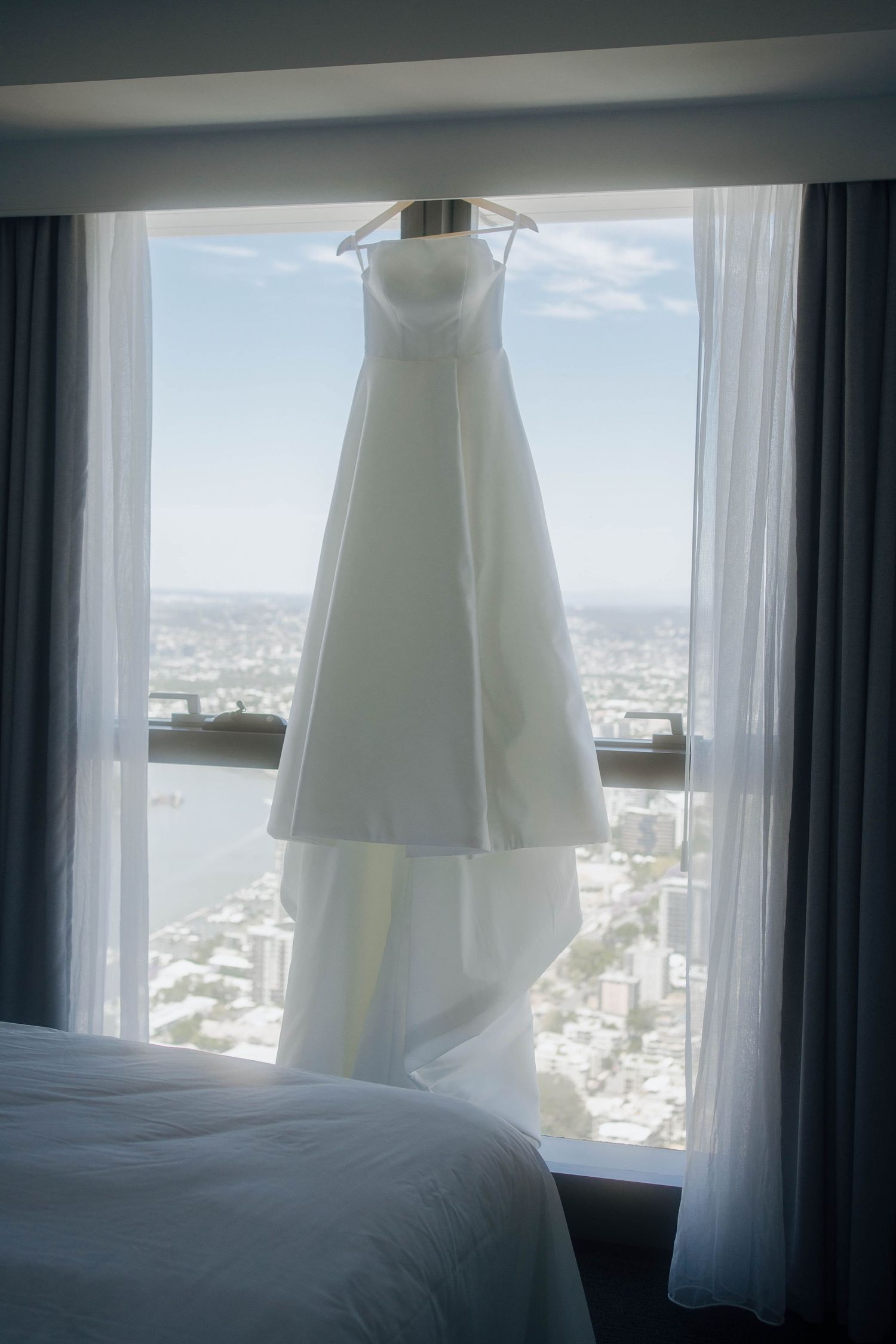 Three views of a bright hotel room window with white curtains overlooking a cityscape on a sunny day.