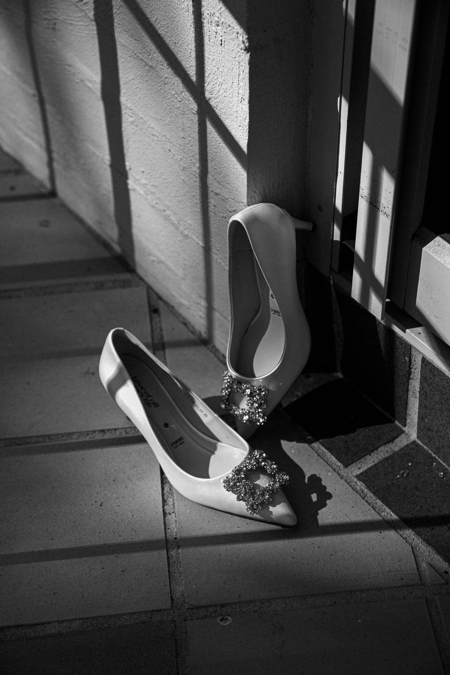 A black and white photo sequence showing a cigarette being extinguished on the ground, casting dramatic shadows.
