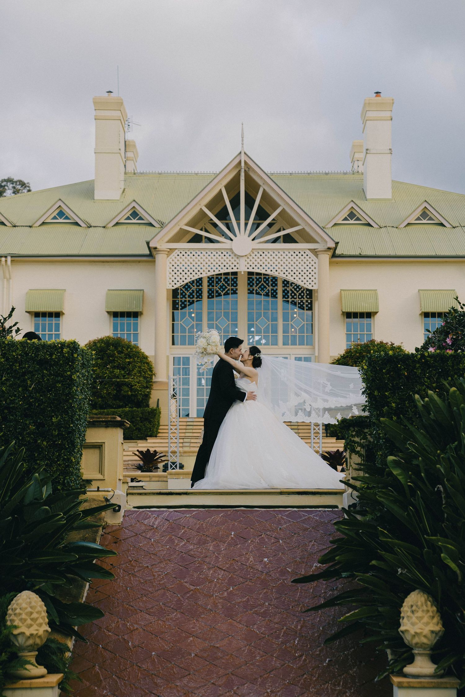 A series of connected photos showing a mansion-style venue with elegant architectural details and manicured landscaping.