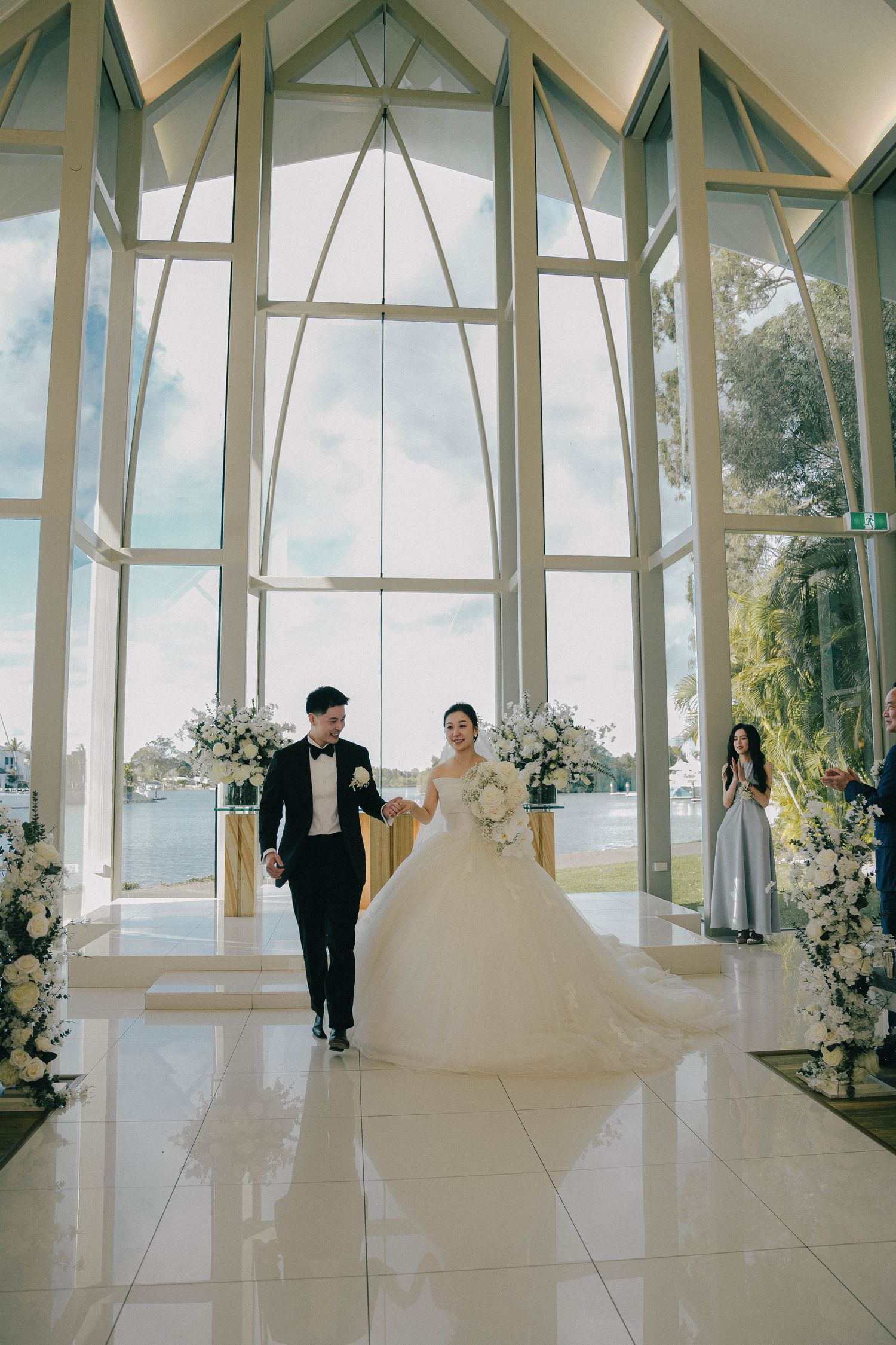 A panoramic sequence of a wedding ceremony in a modern glass chapel with white decor and natural lighting.