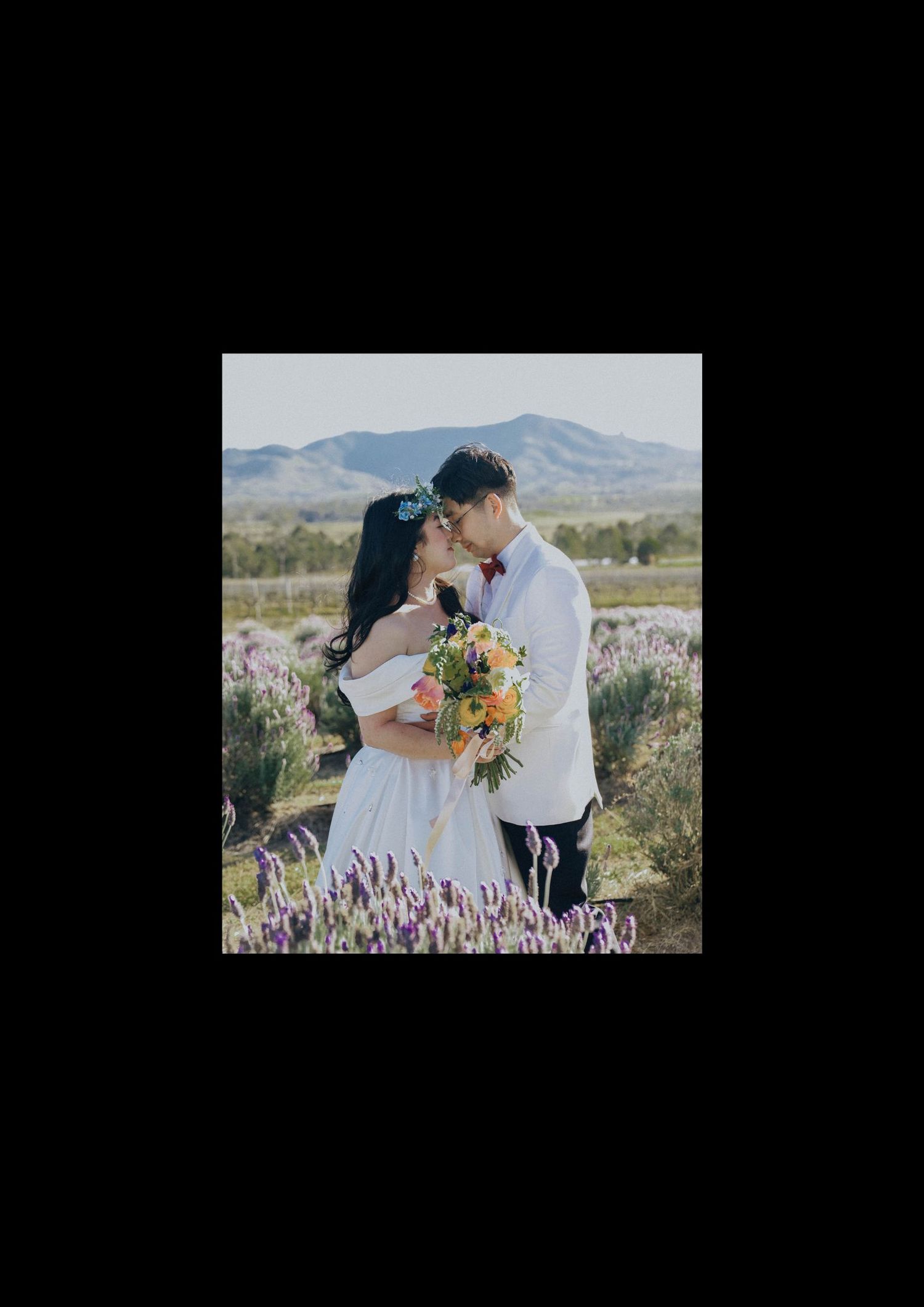 A romantic desert wedding photoshoot with wildflowers and mountains in the background.