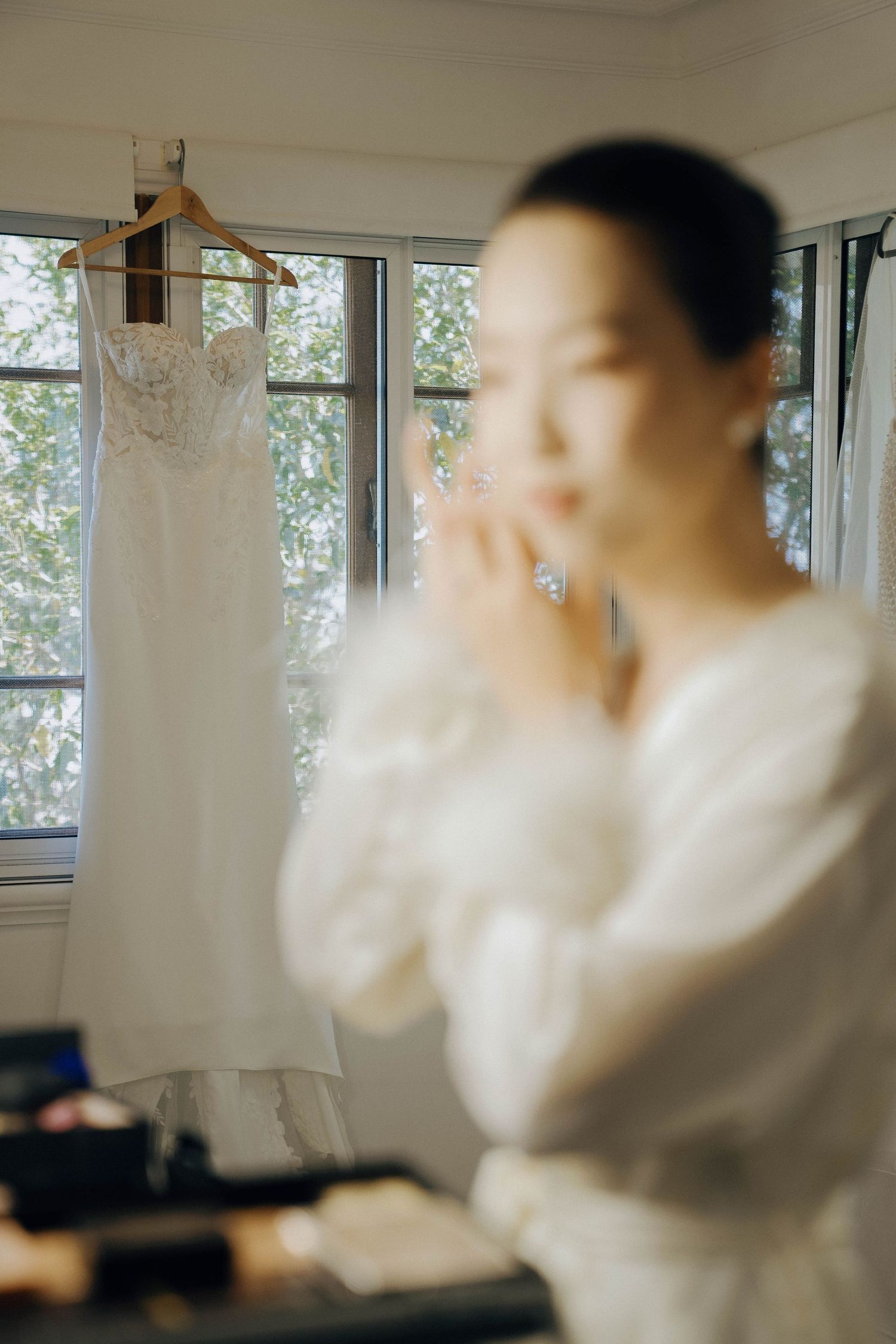 A series of blurred motion photographs showing someone in a white shirt moving through a bright interior space.