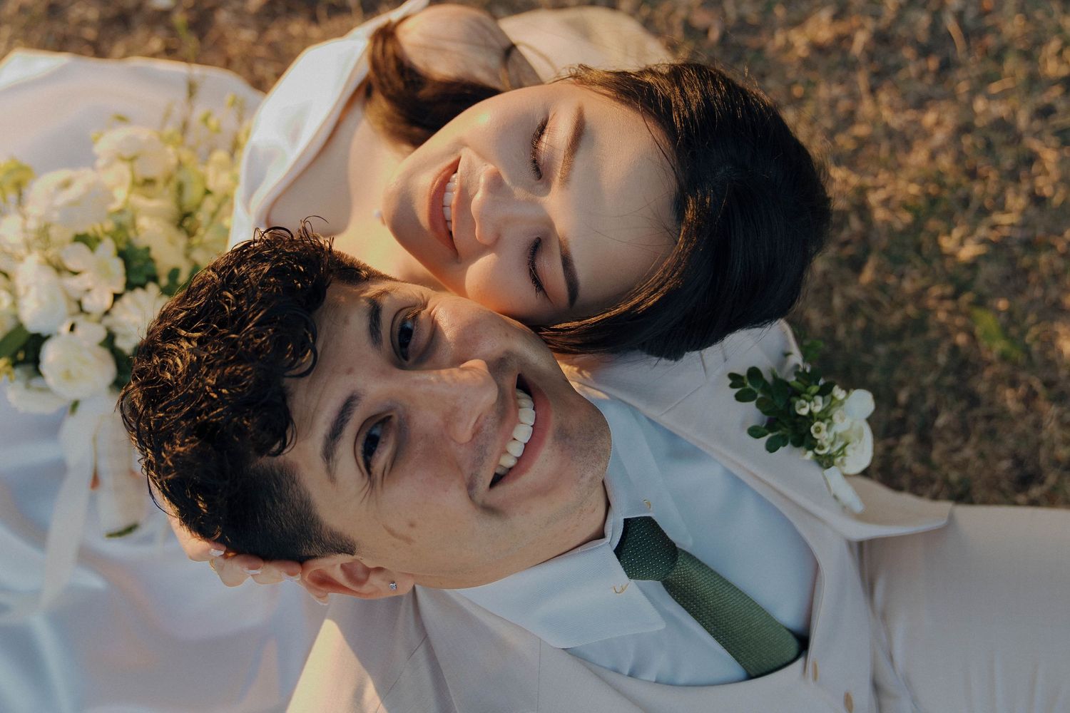Five connected images show a person in white lying on autumn leaves with flowers nearby, creating a dreamy outdoor portrait.