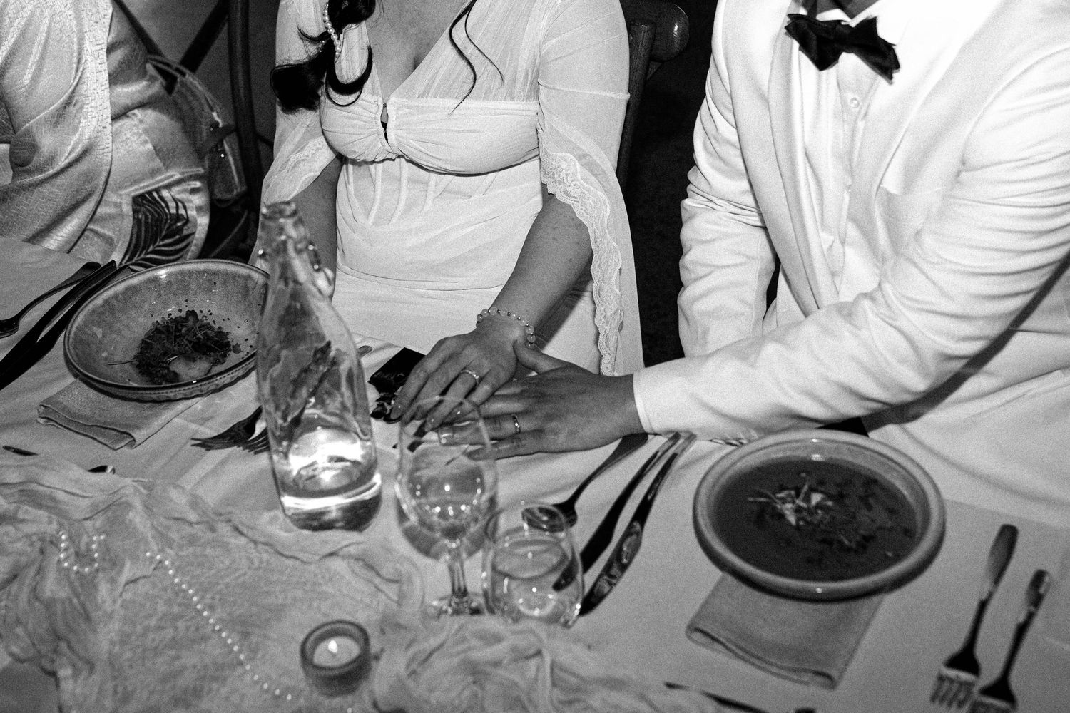 Black and white photos show hands preparing and serving food at an elegant dinner service.