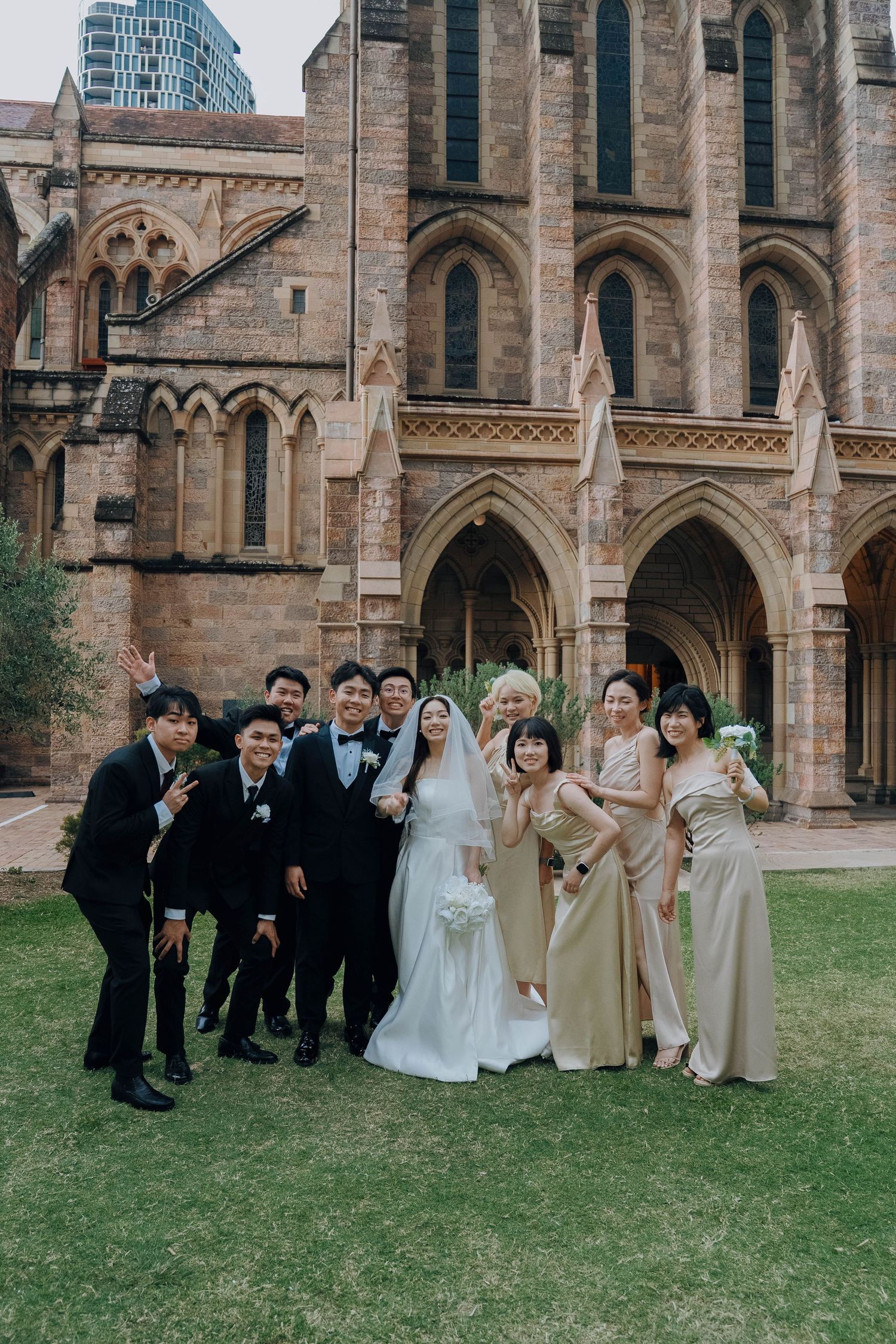 Wedding party poses in front of Gothic church architecture in three similar group shots.
