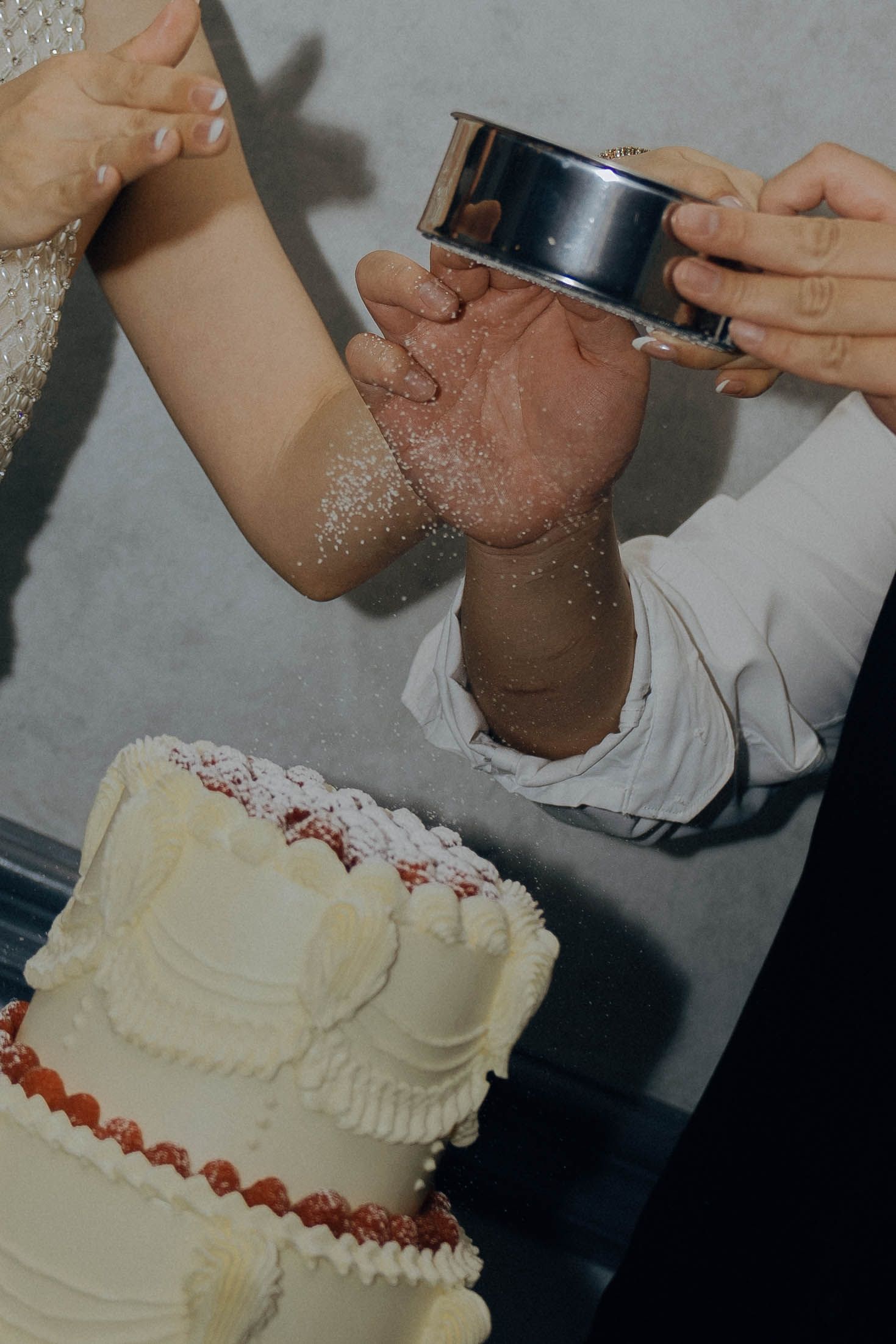 A series of four photos showing the process of decorating a white frosted cake with piped borders and details.