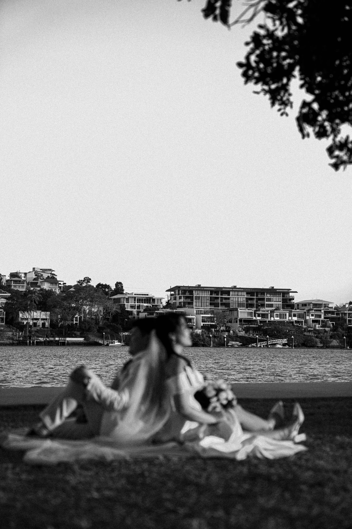 A black and white panoramic sequence showing a person rolling down a grassy hill with buildings in the background.