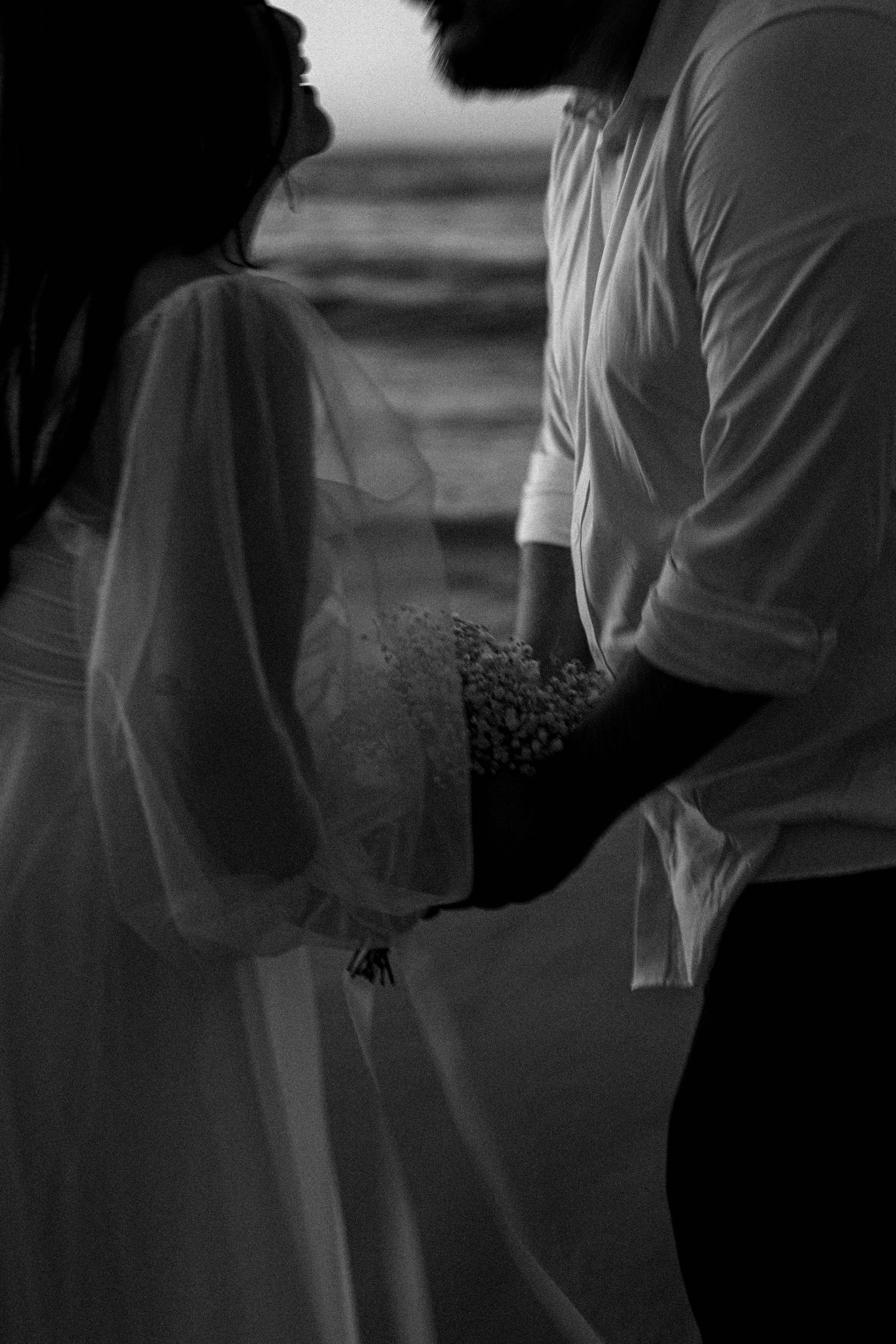 A black and white artistic photo series showing couples holding hands in silhouette against a dark background.