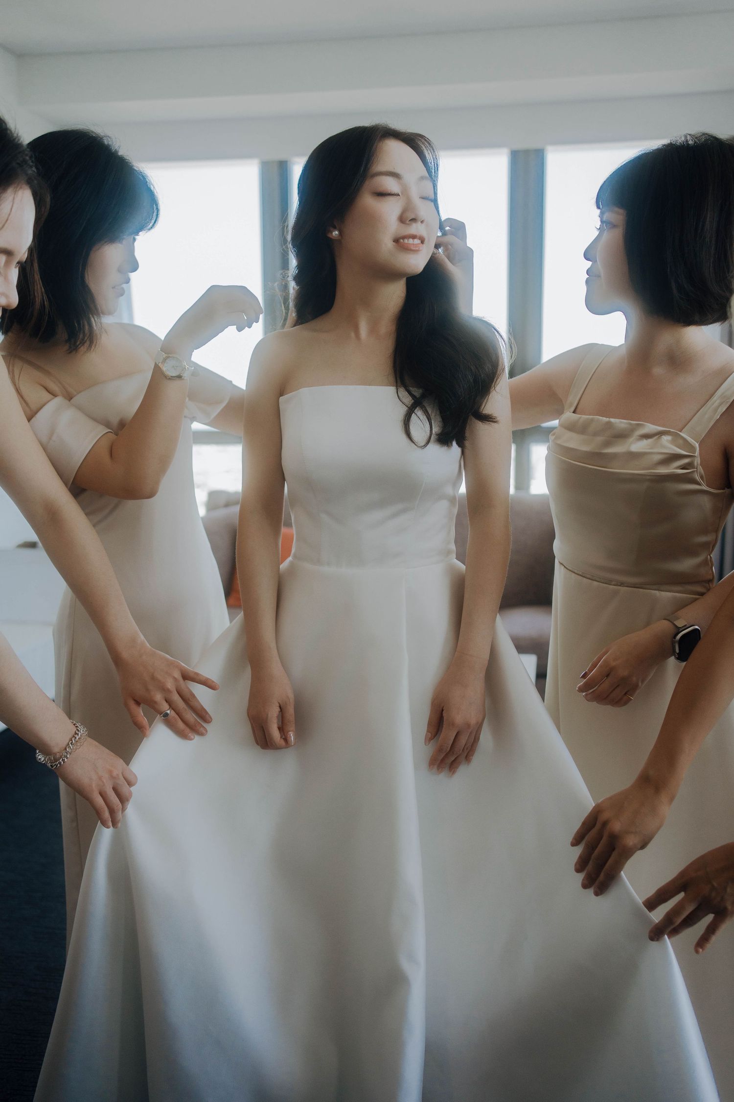 A sequence of photos showing a woman in a white wedding dress posing and dancing in a bright room.