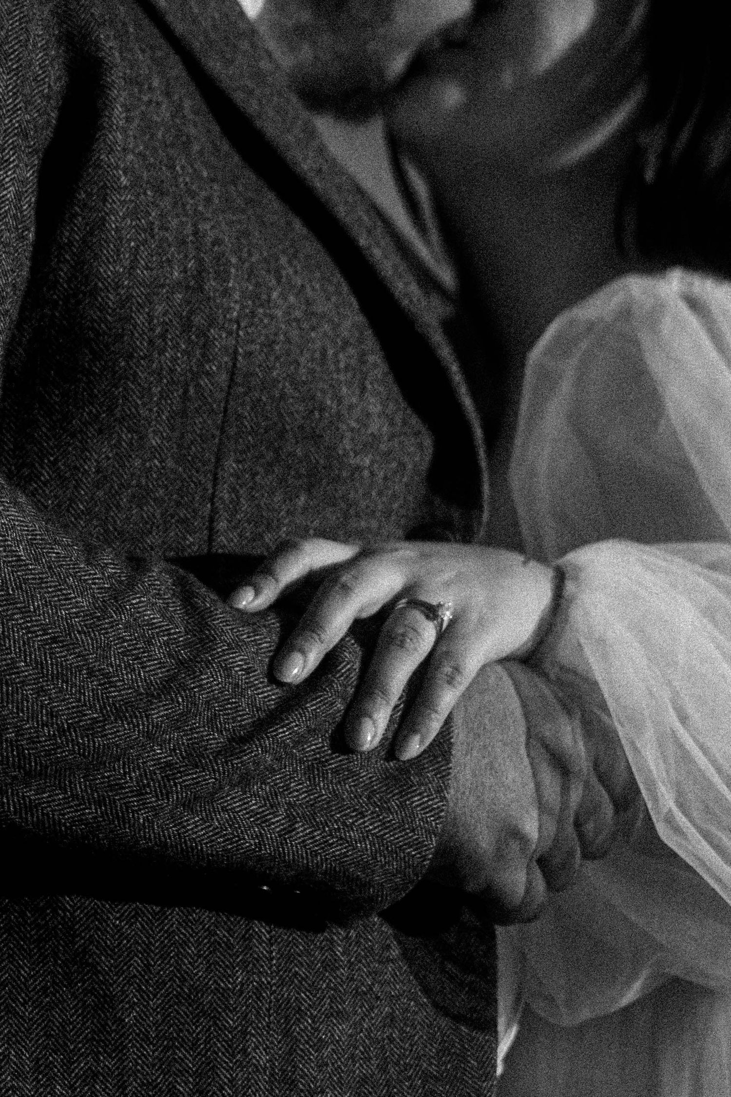 Black and white close-up photo sequence showing hands gently holding delicate white tulle fabric.