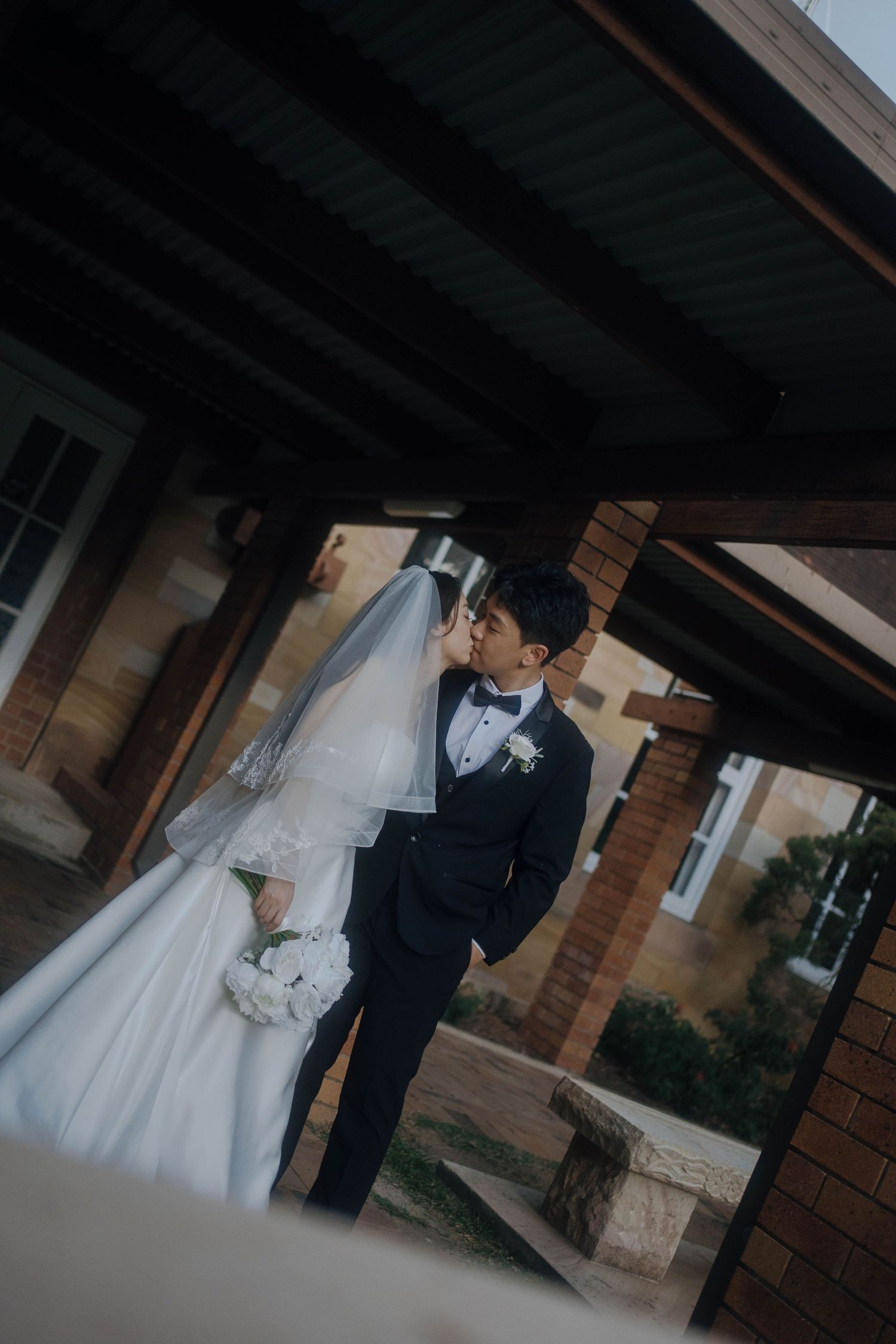 A sequence of wedding photos showing silhouettes against a building exterior with dramatic lighting.