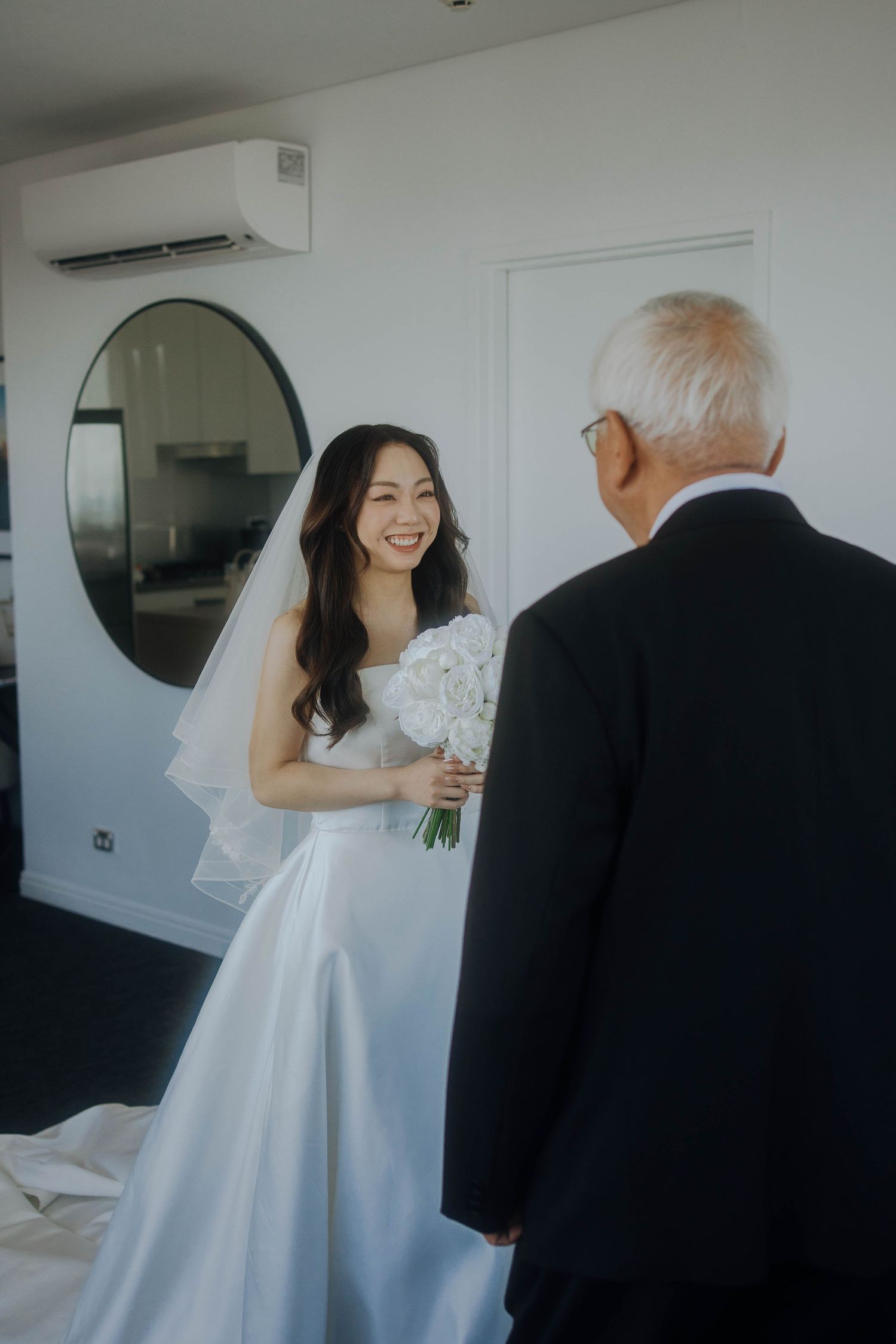 A series of four candid wedding photos showing emotional moments between a bride in white and an elderly guest.