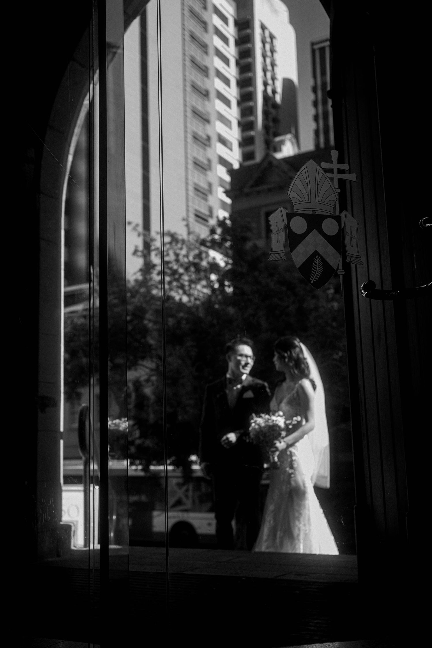 A sequence of black and white photos showing a silhouette of a couple in a window frame, creating a dramatic lighting effect.