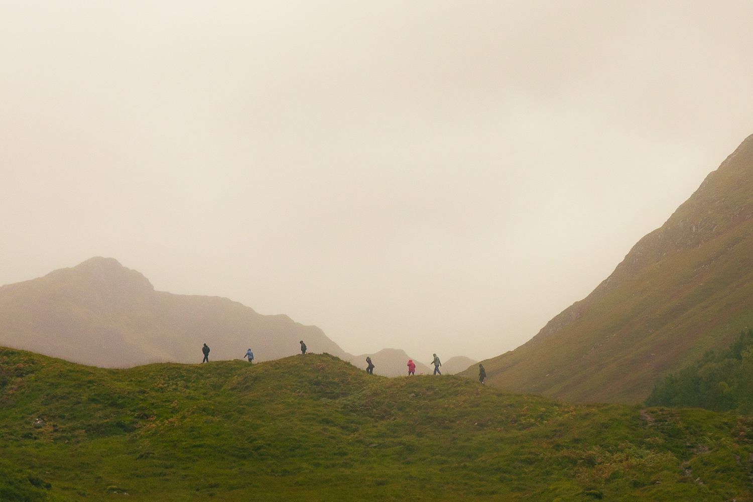 Travelers walking at Glen Shiel Viewpoint in Scotland.