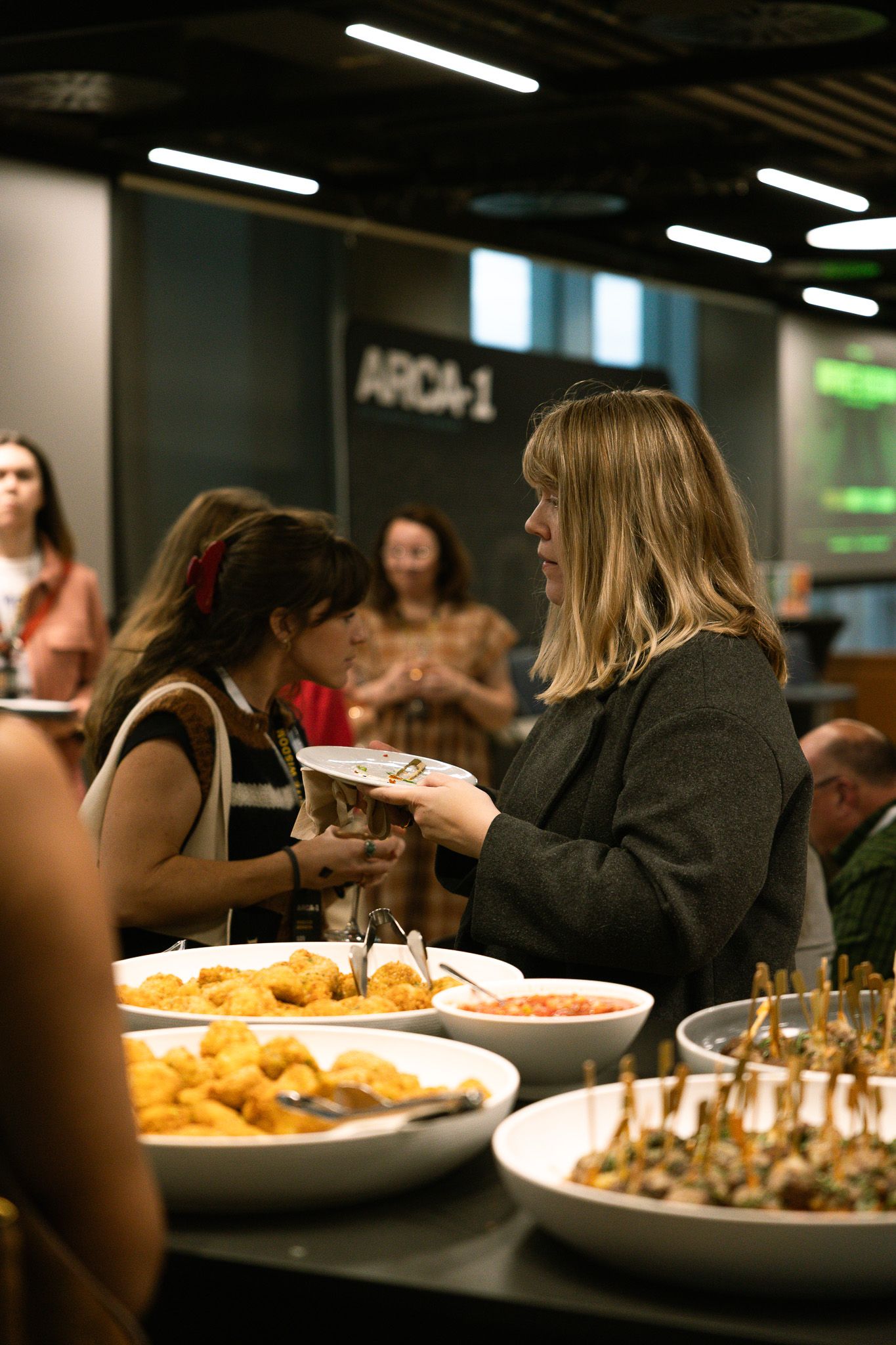 Guests enjoy catering at the Thomas Weaver Arca-1 Infinite Wisdom Release Event at Penguin Random House Headquarters in London, England.