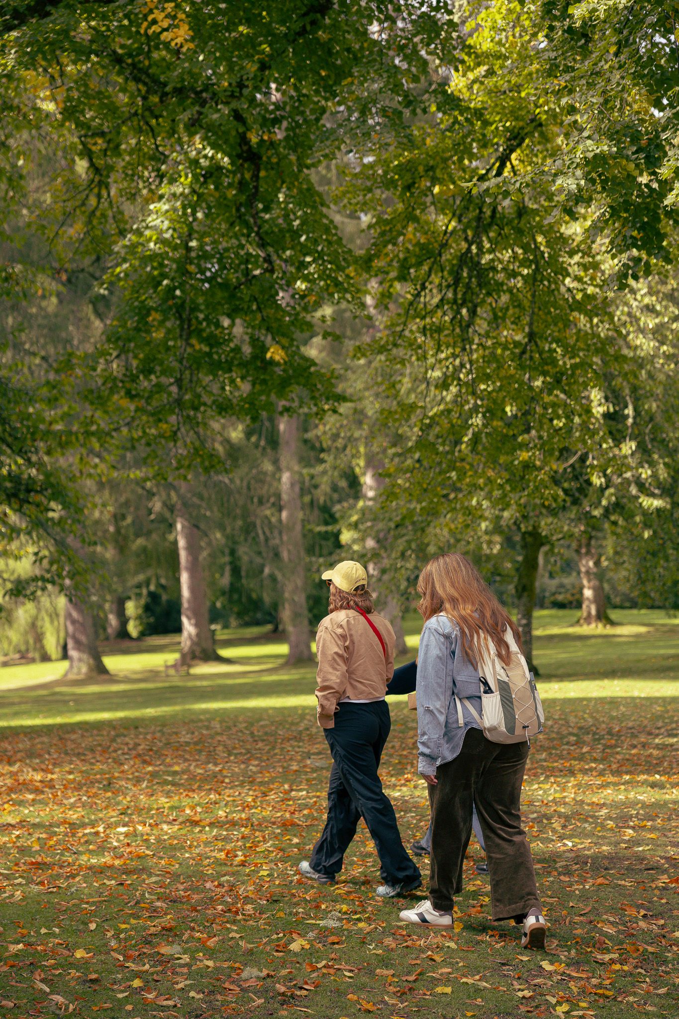 Girls walking in fields near Dunkeld Cathedral.