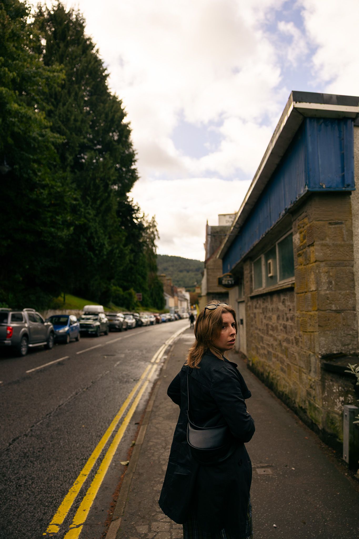Candid photo of a girl walking down the street in Dunkeld, Scotland