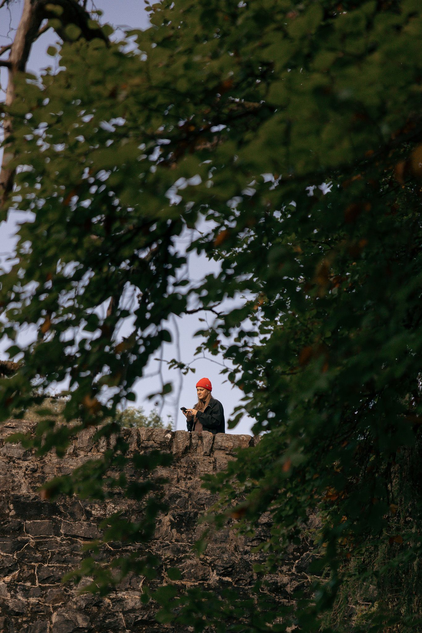 Girl walking on bridge near Invermoriston Falls.