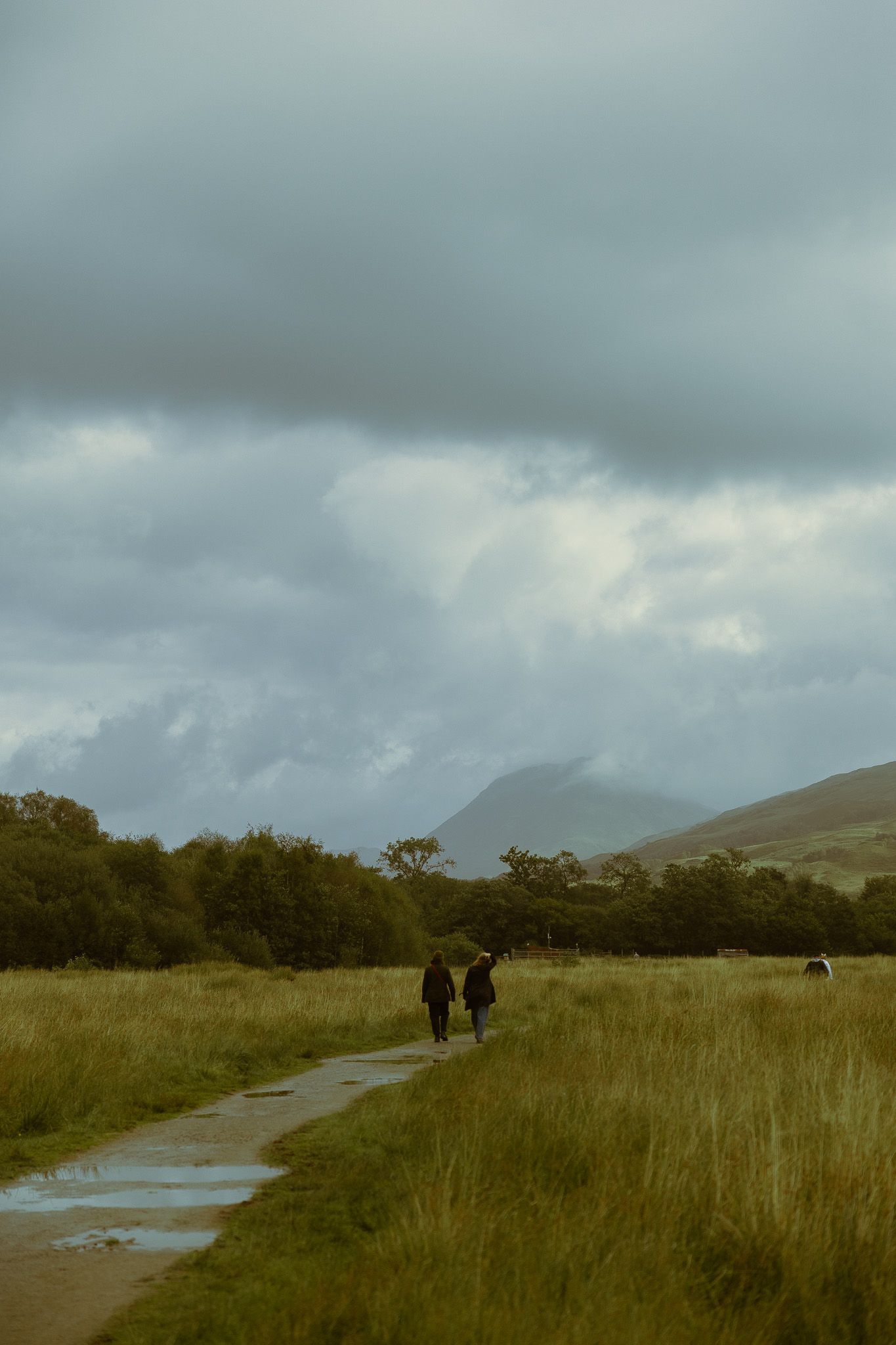 Girls walking the trail at Kilchurn Castle, Scotland.