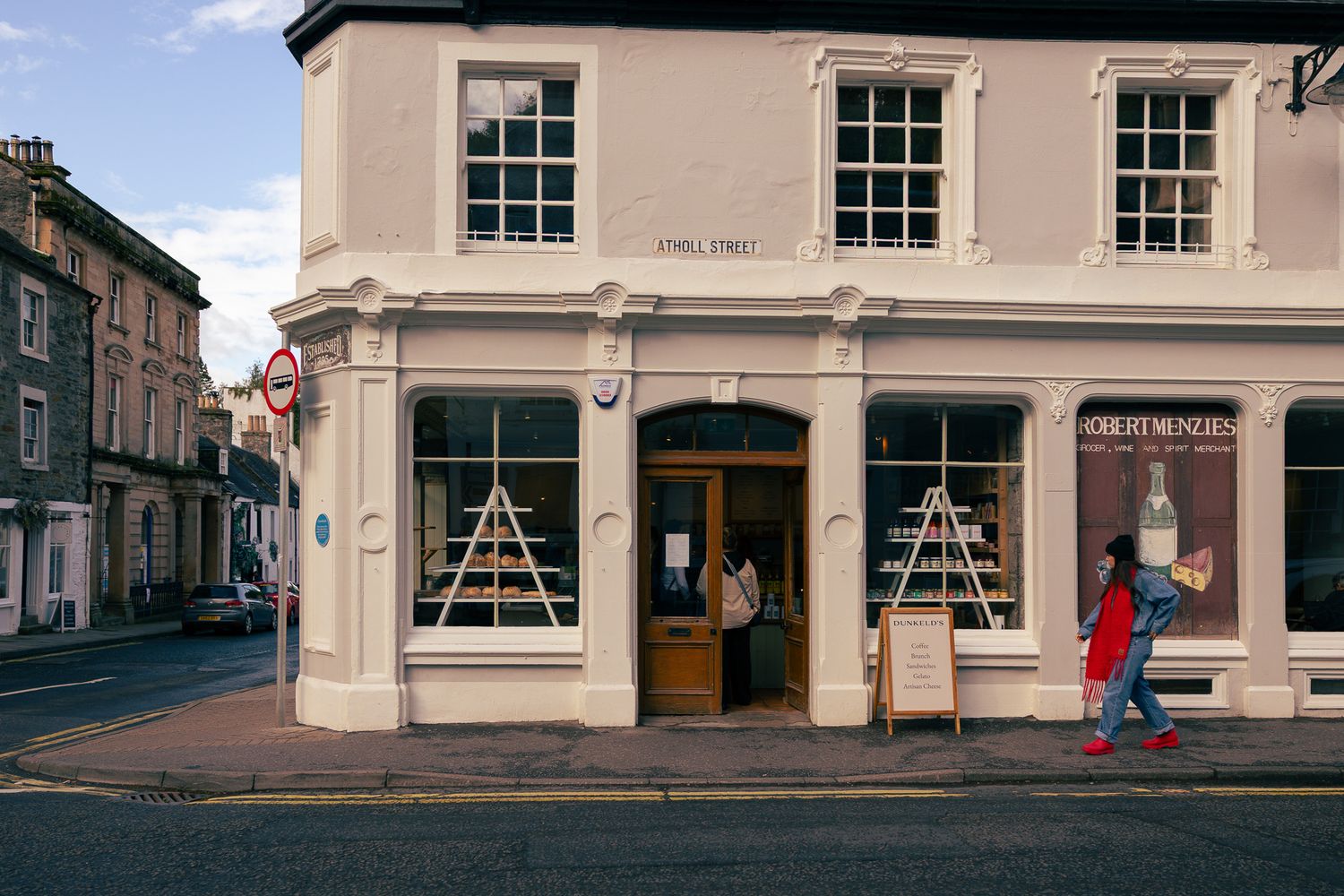 Girl walking outside a cafe in Dunkeld, Scotland.