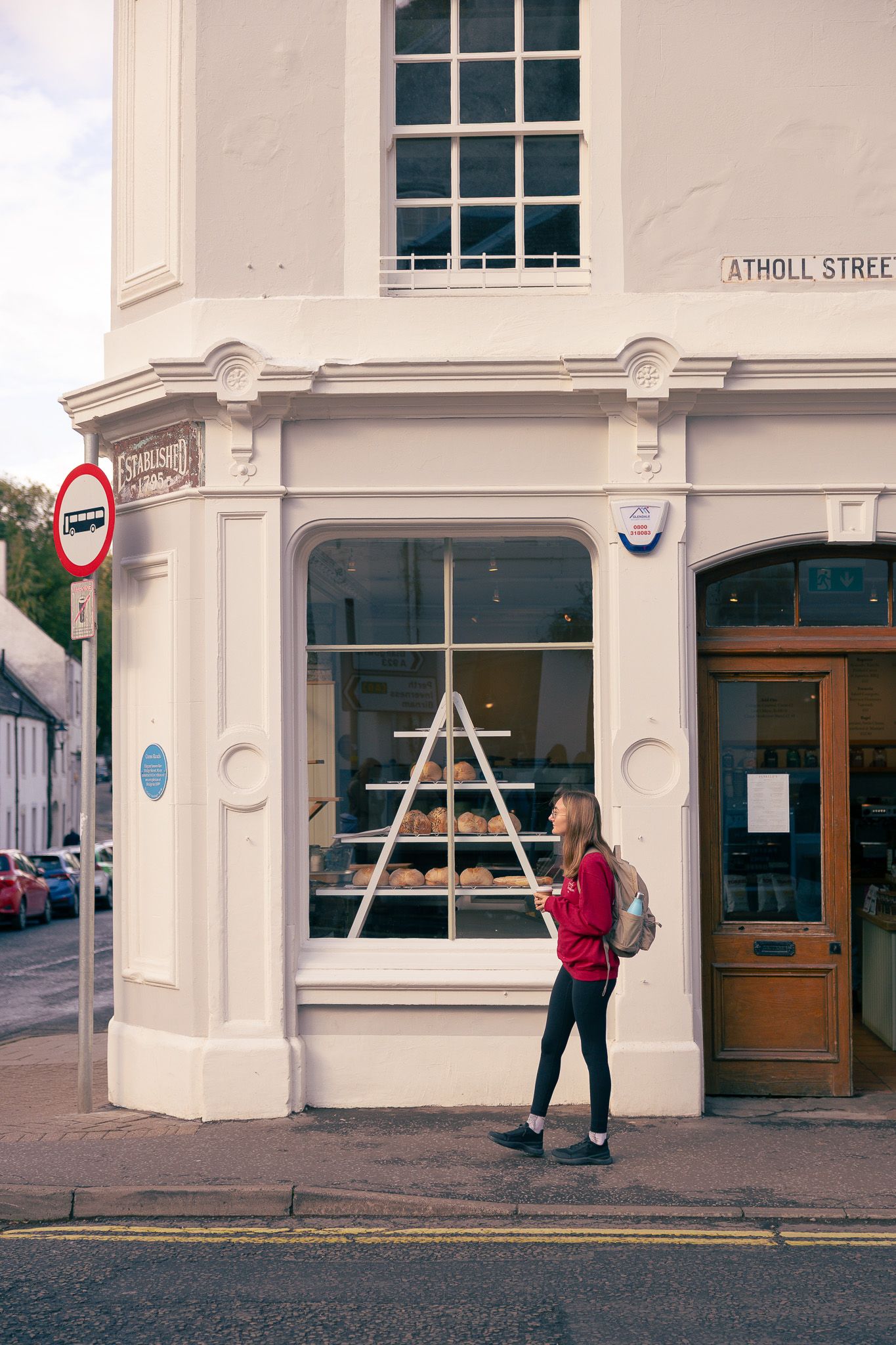 Girl walking outside a cafe in Dunkeld, Scotland.