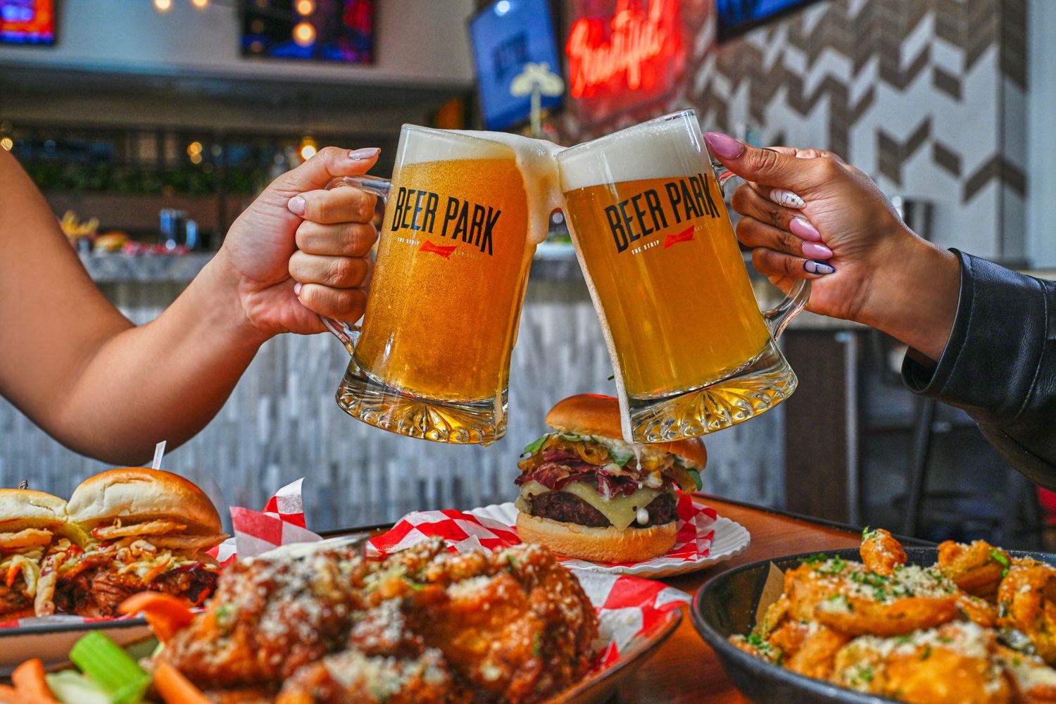 guests cheering with beer during a lively dining experience in Las Vegas